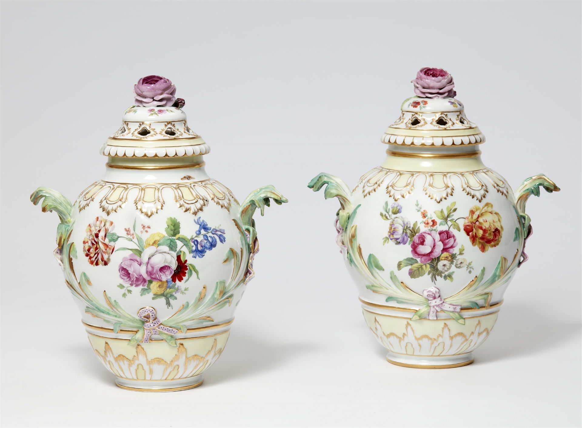 A pair of Berlin KPM porcelain potpourri vases with naturalistic flowers