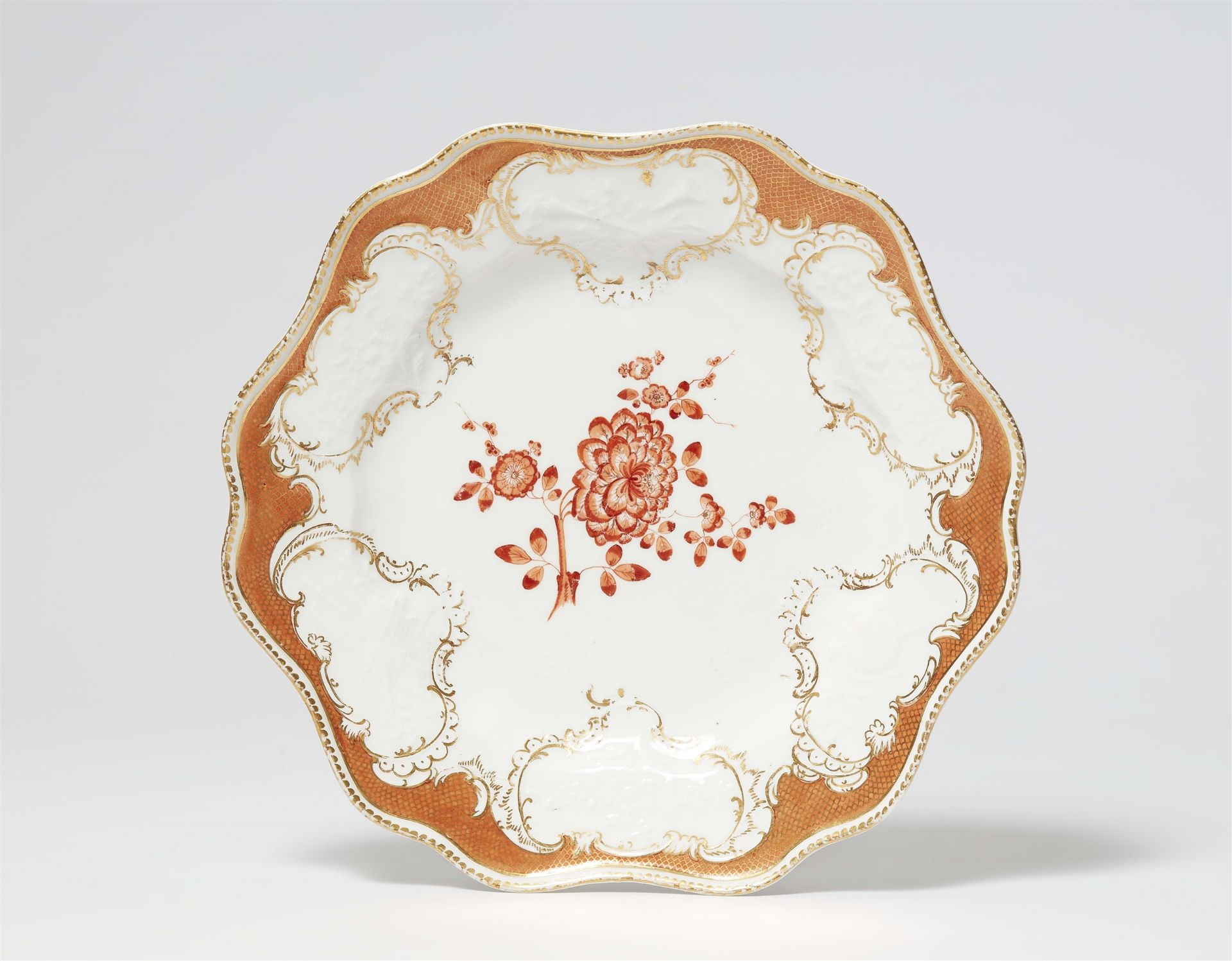 A Meissen porcelain dinner plate from a service with iron red mosaic borders