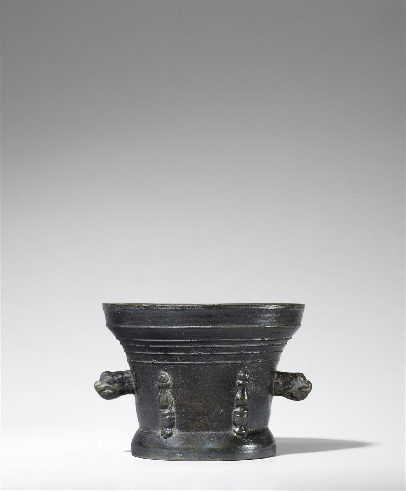 A mortar with lion's head handles