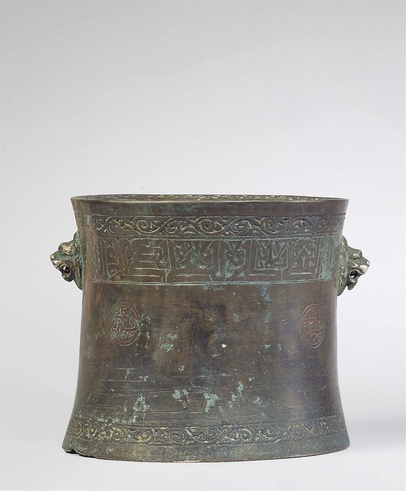 An Islamic mortar with lion's head handles