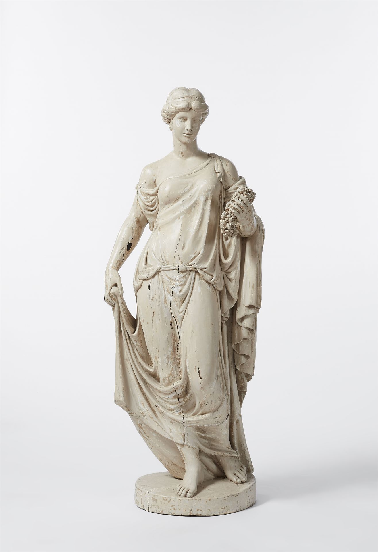 A carved softwood figure of a lady with a wreath / Flora