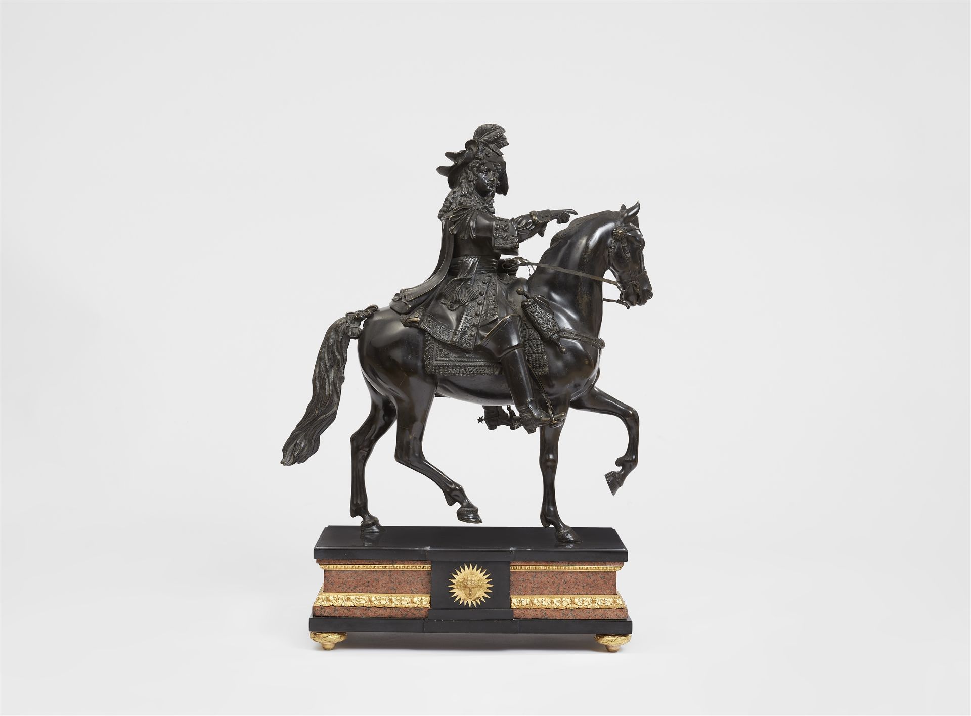 A bronze figure of Louis XIV riding into battle