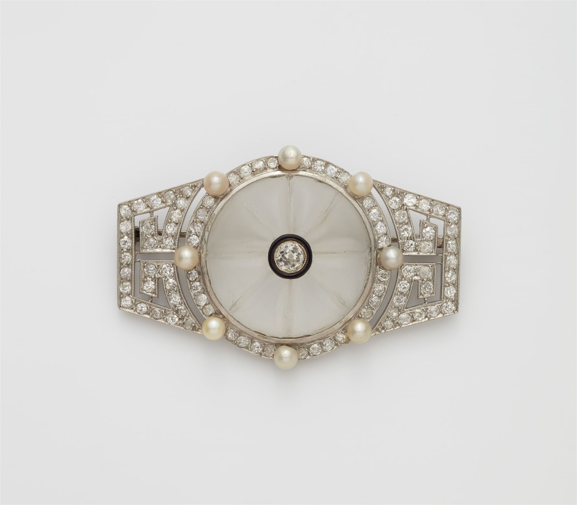 A French Art Déco platinum enamel diamond and rock crystal brooch.