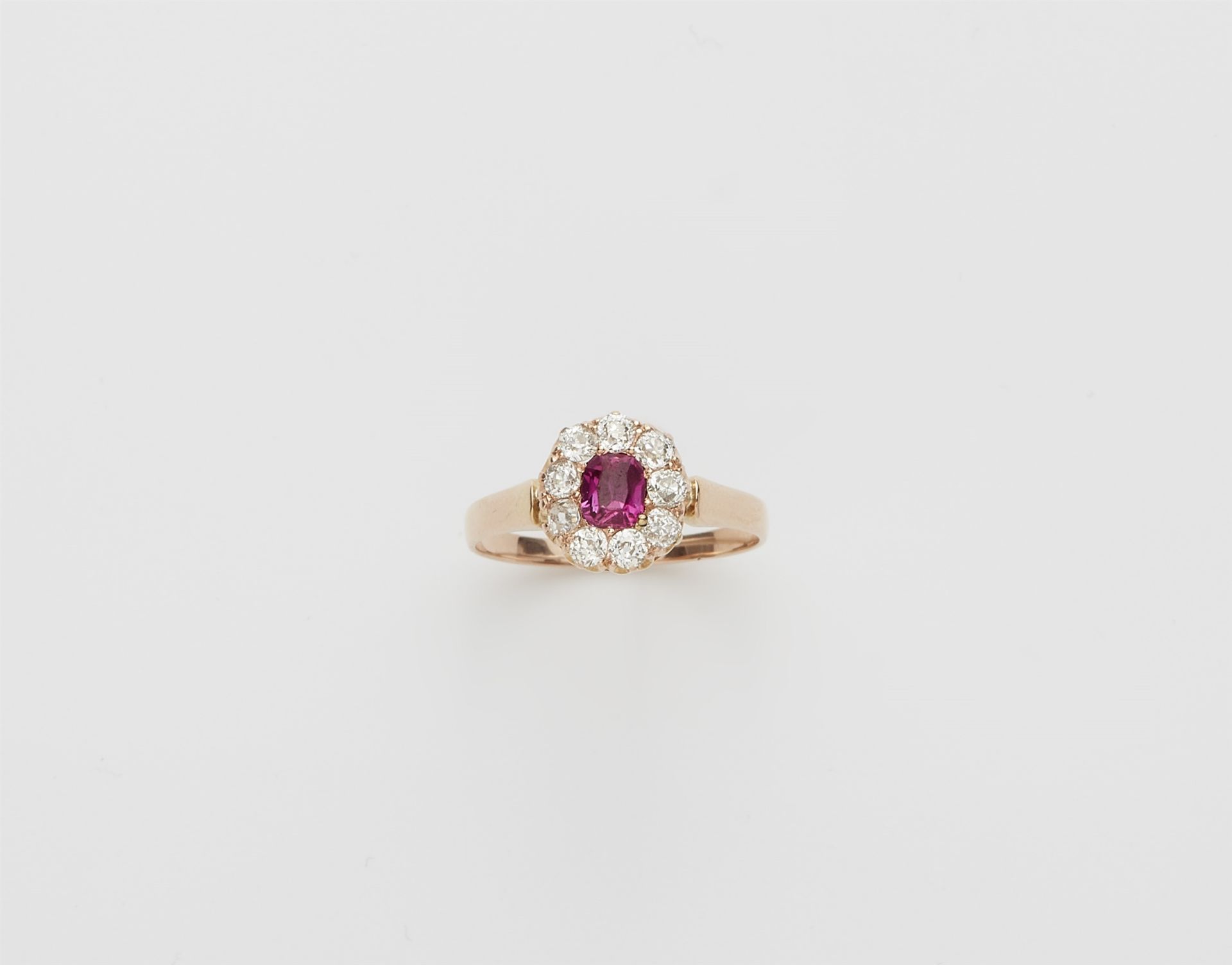 A 14k rose gold diamond and pink Burmese ruby cluster ring.