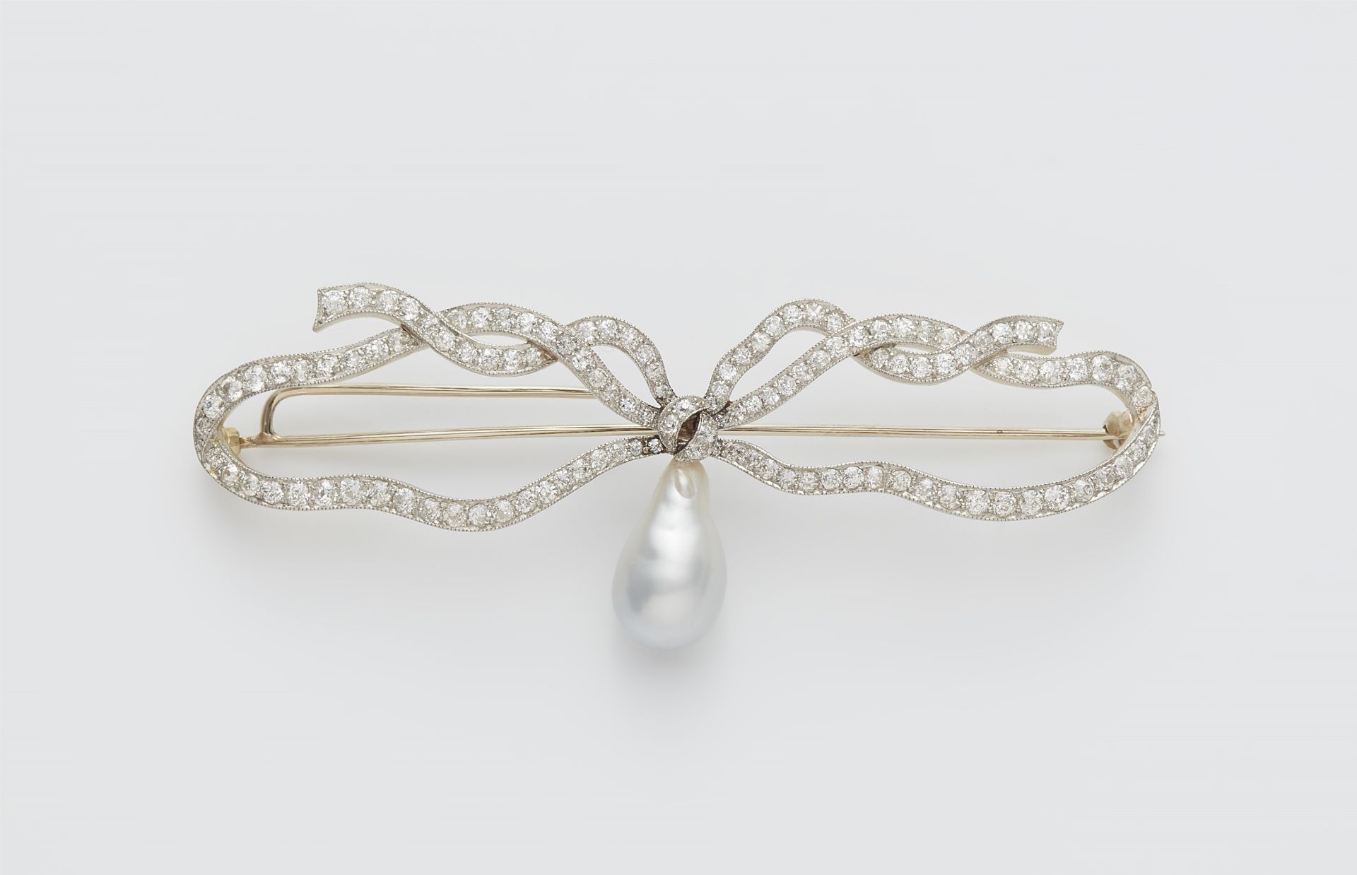 A 14k gold Belle Epoque diamond brooch with a later South Sea pearl droplet.