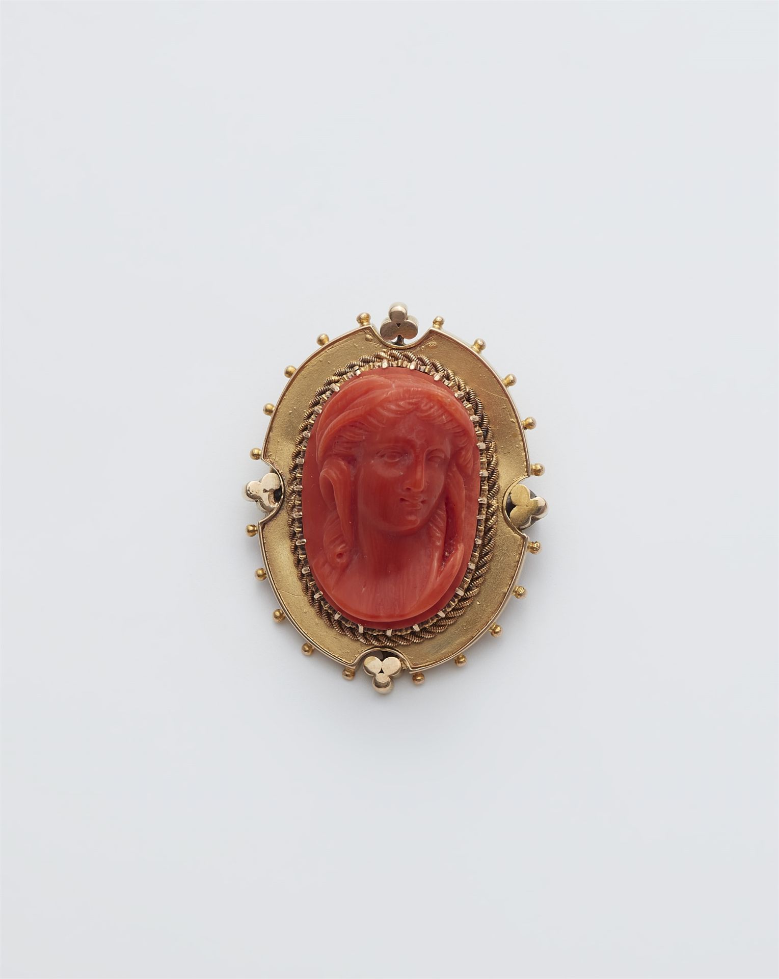 A probably Victorian 14k gold and red Sicilian coral cameo brooch.