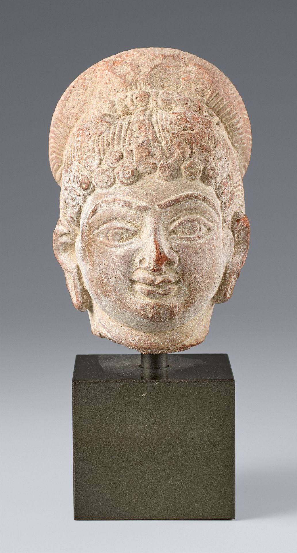 A small red terracotta head of a female. Central India. Possibly Gupta period