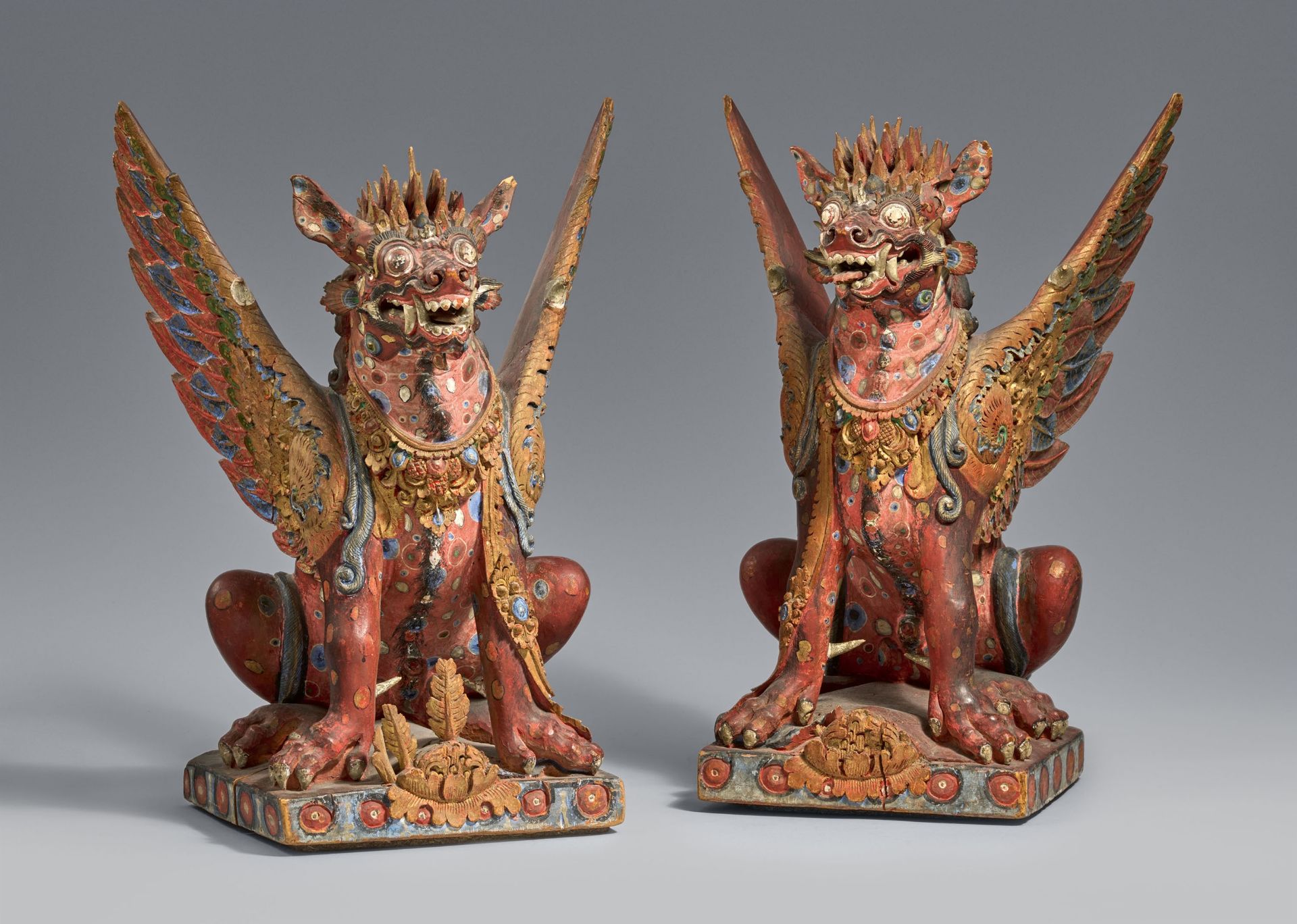 Two Bali polychromed wood figures of winged lions (singha). Indonesia. 20th century