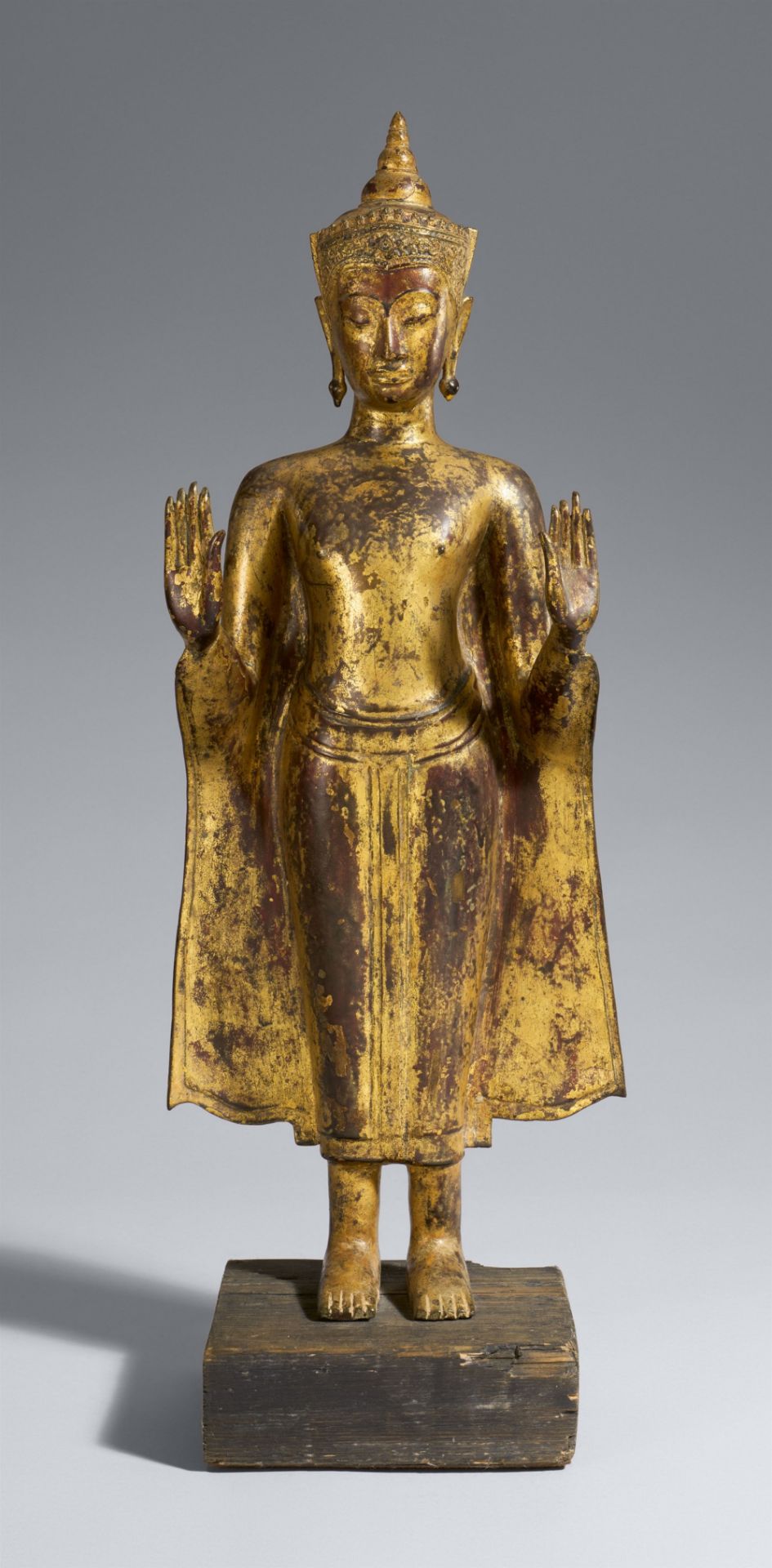 An Ayutthaya gilt and lacquered bronze figure of a crowned Buddha Shakyamuni. Thailand. 16th/17th ce
