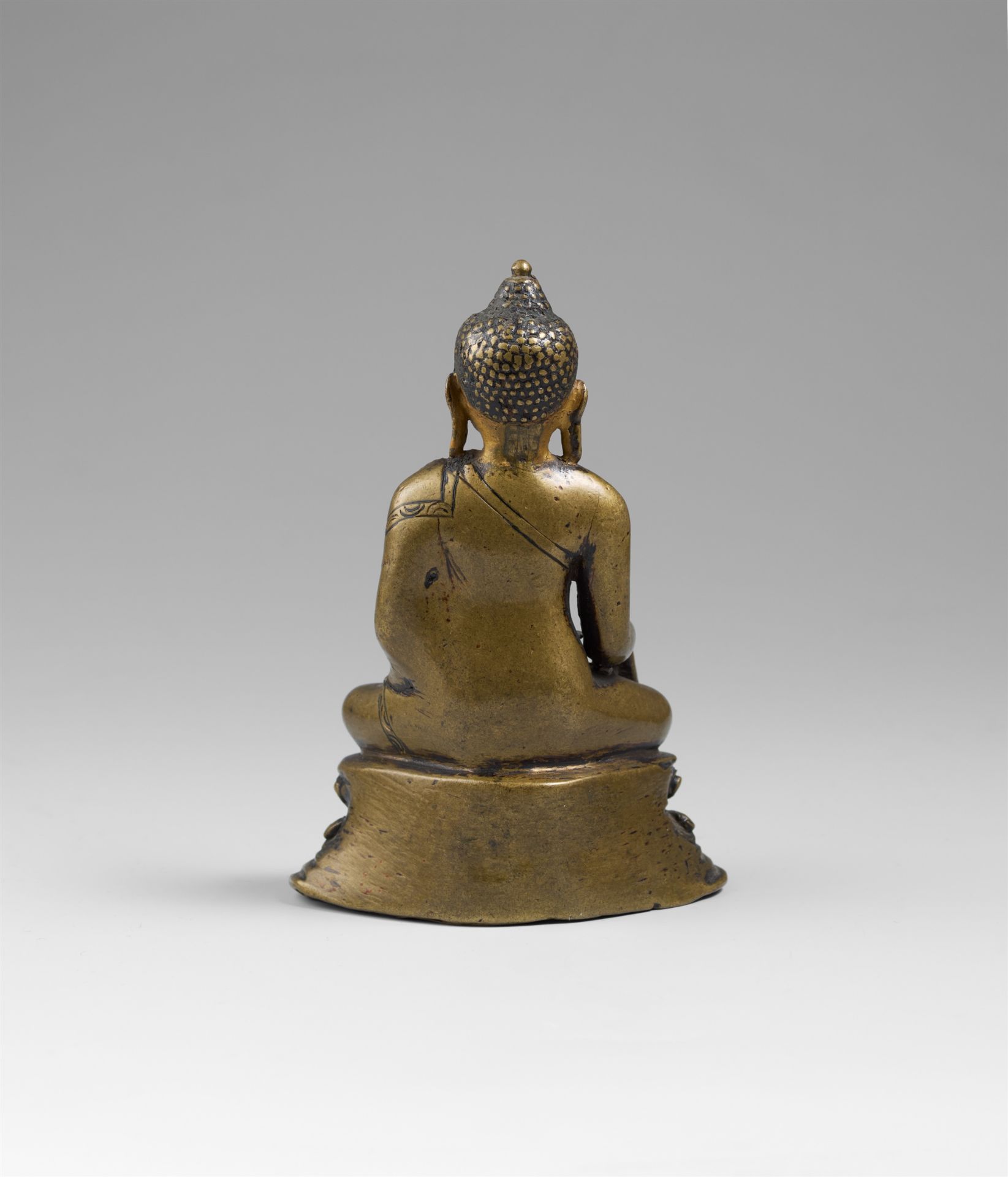 A Tibetan copper alloy figure of Buddha Shakyamuni with cold gold. 14th/15 century - Image 2 of 2