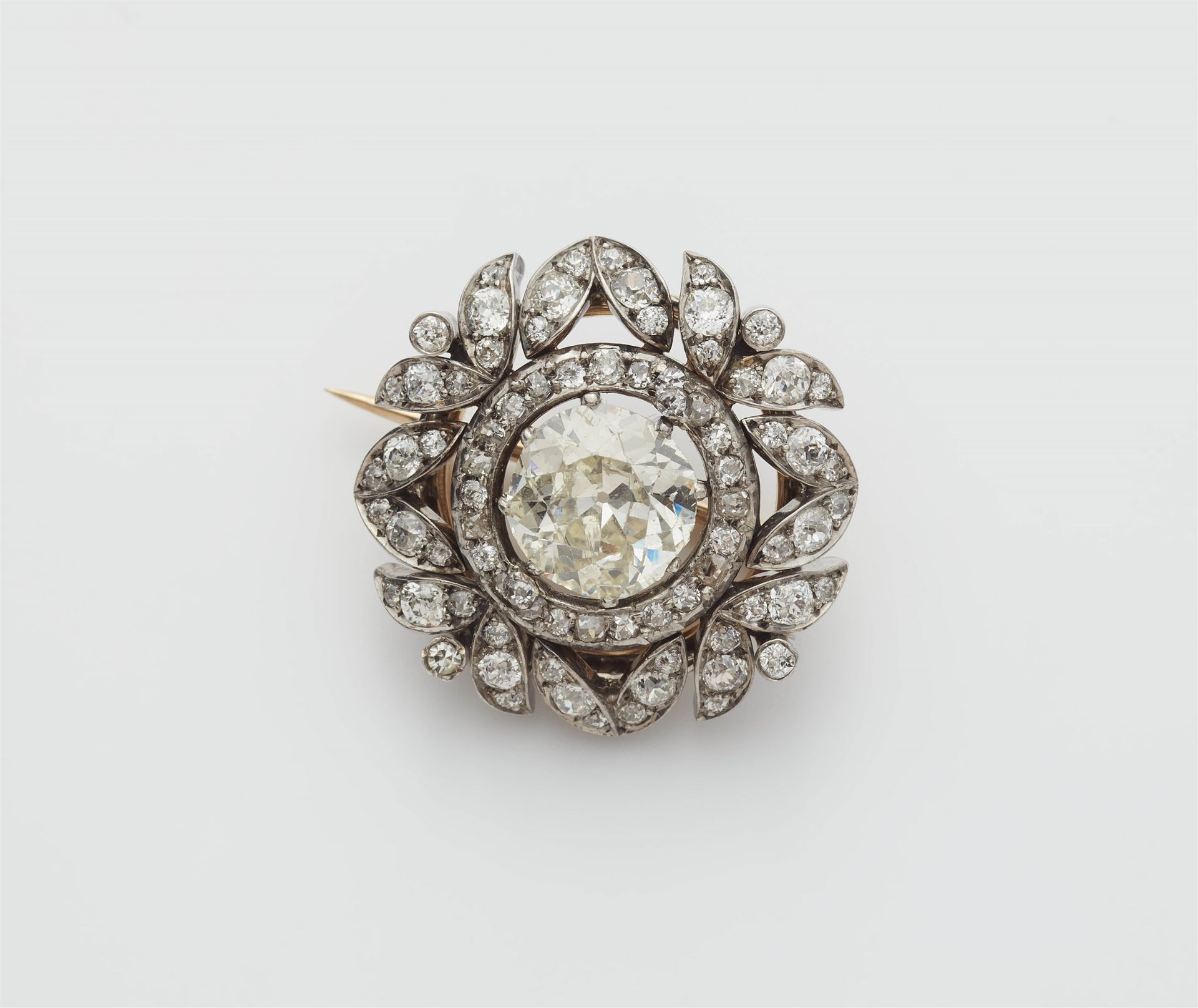 A Viennese 14k gold diamond brooch with a ca. 3.23 ct European old-cut centre stone.