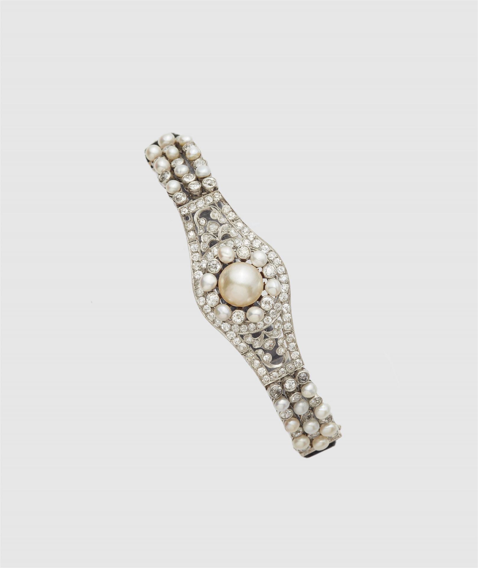 A French platinum diamond and pearl buckle bracelet with later velvet strap.