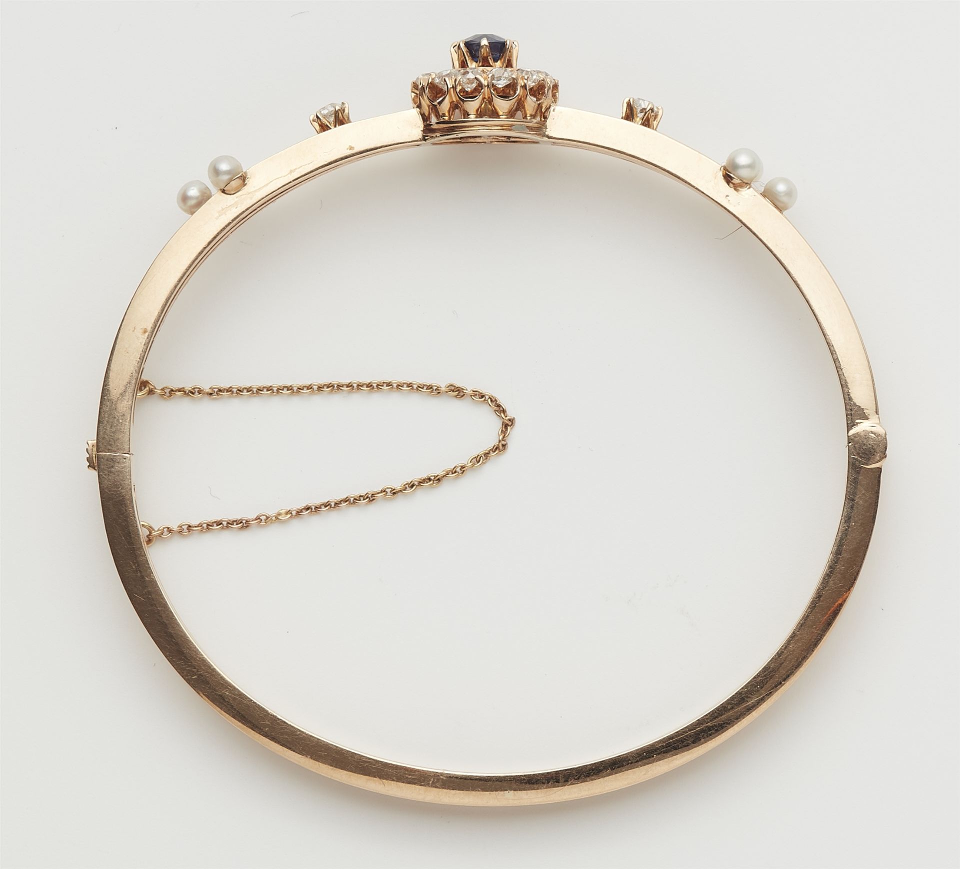 A late 19th century 14k rose gold diamond pearl and fine sapphire bangle. - Image 2 of 3