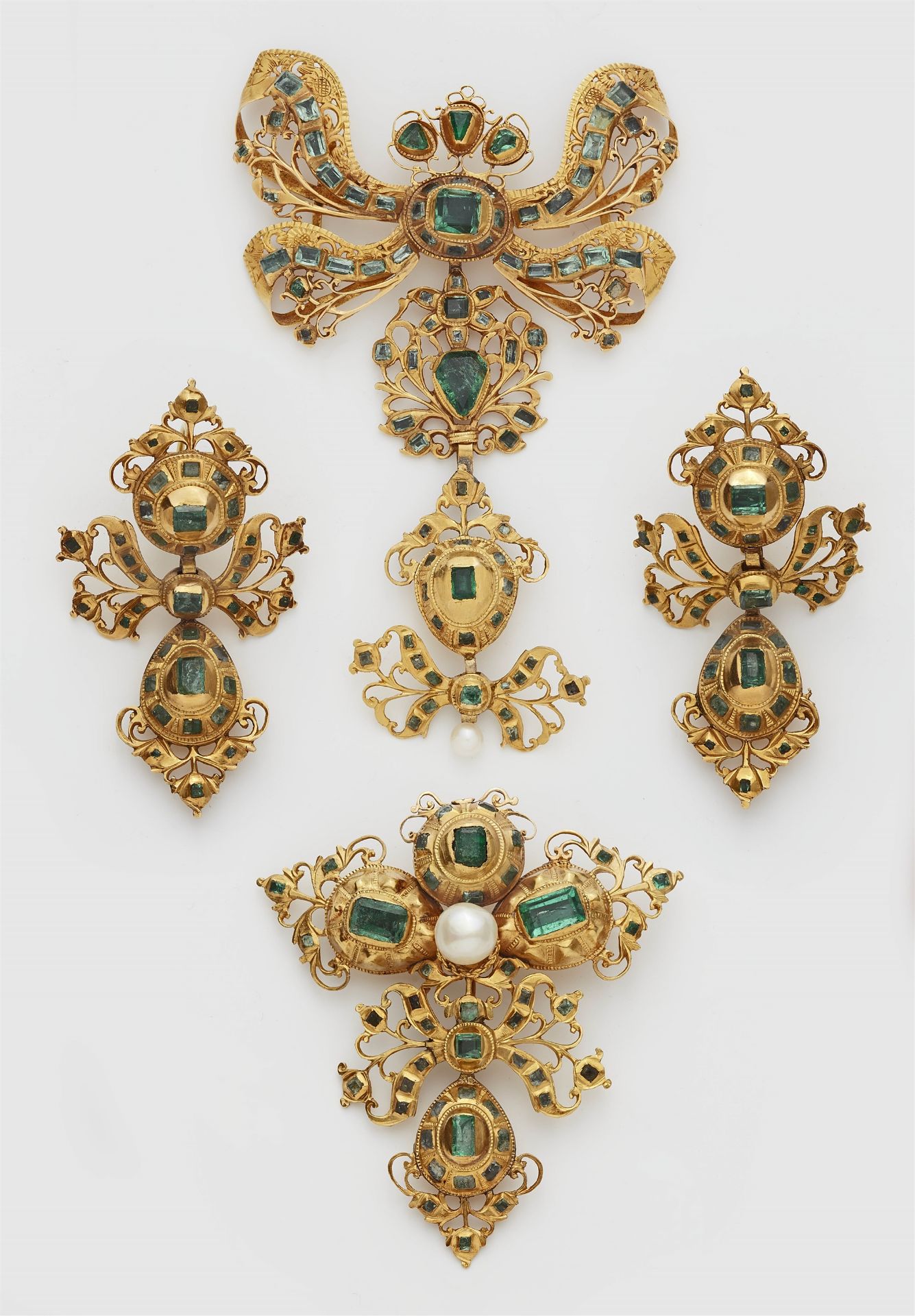Parts of a Spanish 18k gold and emerald Rococo suite.