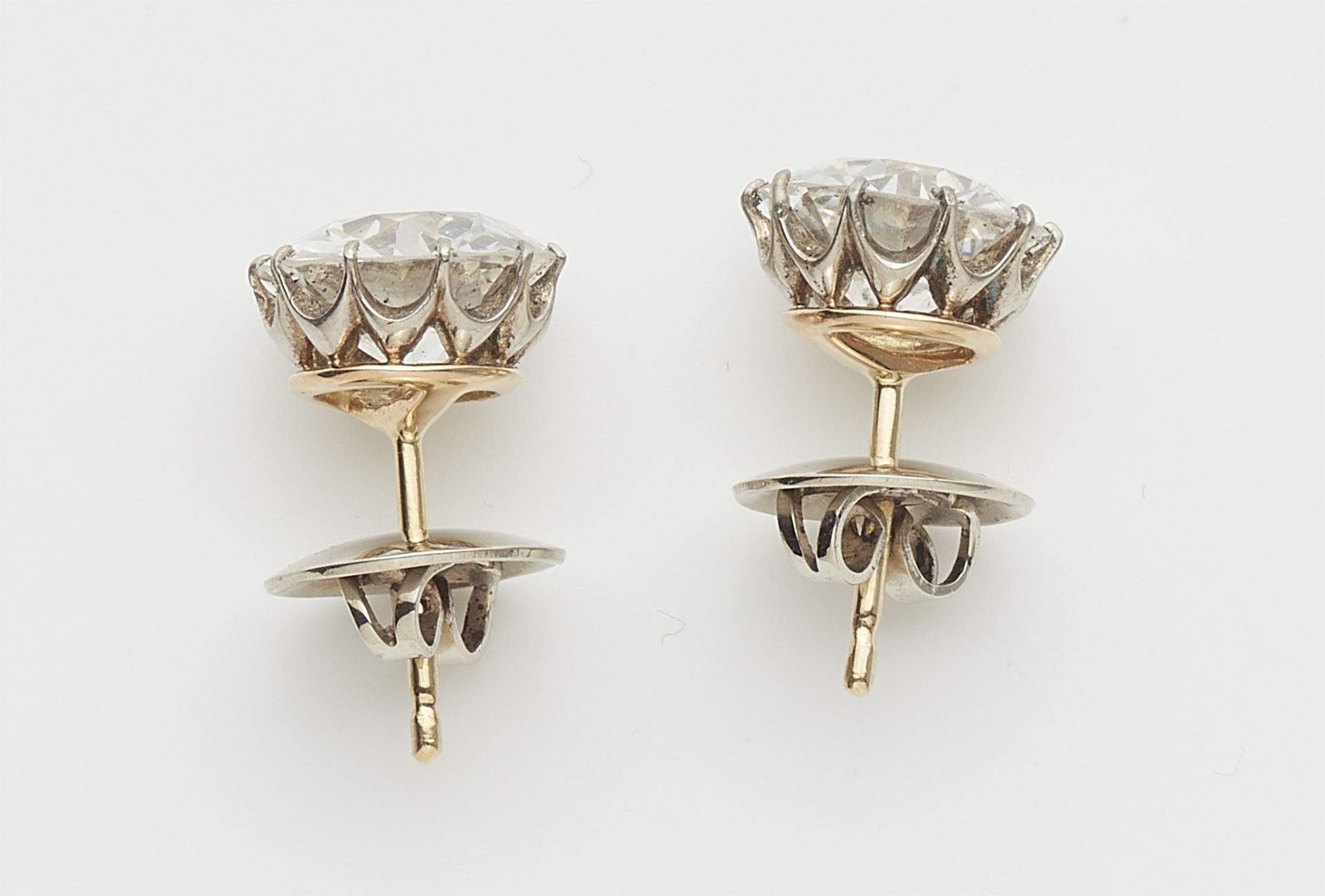 A pair of 14k gold and transition-cut diamond solitaire stud earrings. - Image 2 of 3