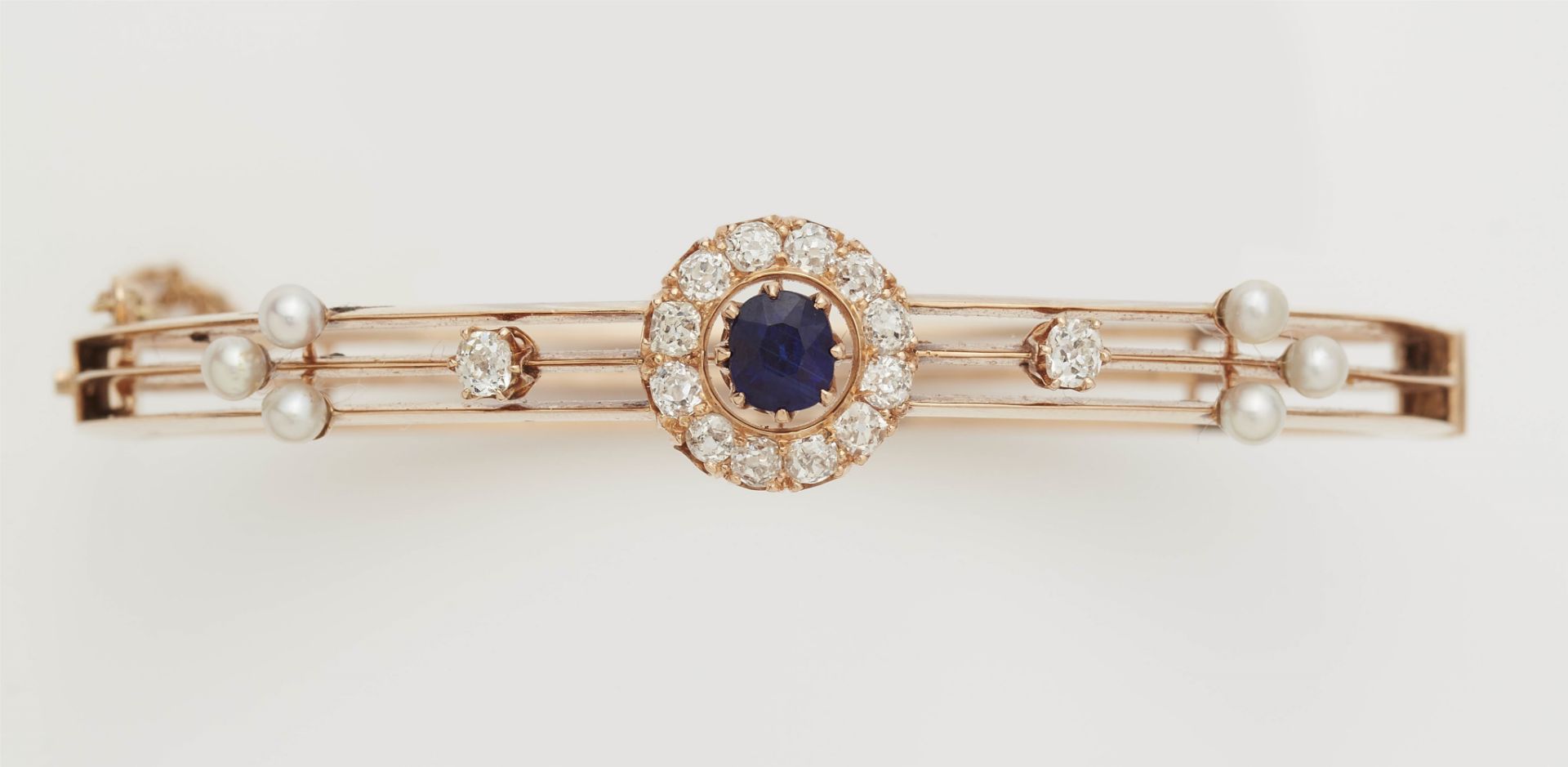 A late 19th century 14k rose gold diamond pearl and fine sapphire bangle. - Image 3 of 3
