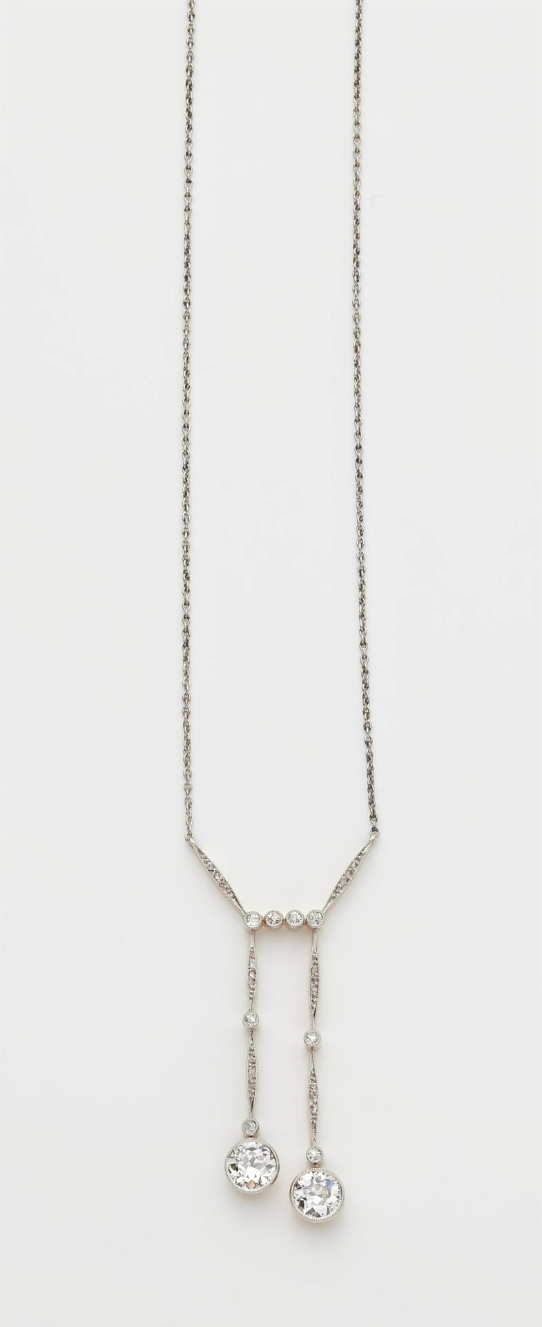 A 14k gold diamond negligé pendant necklace with two transitional-cut diamond solitaires.