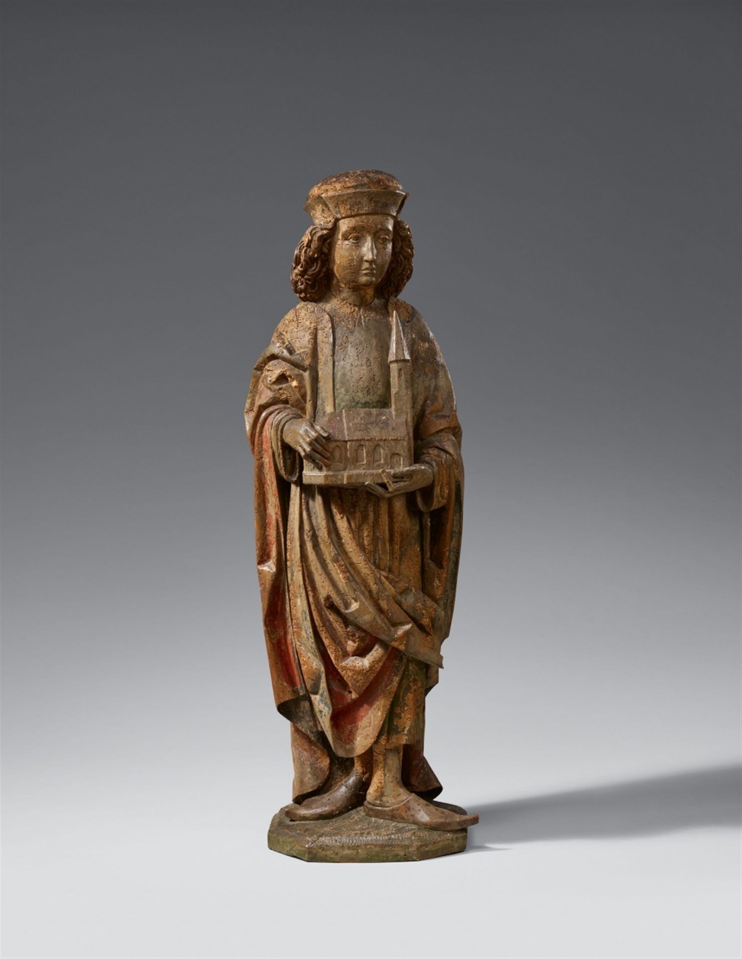 A high relief figure of a Saint with a church model, probably Austrian, around 1500