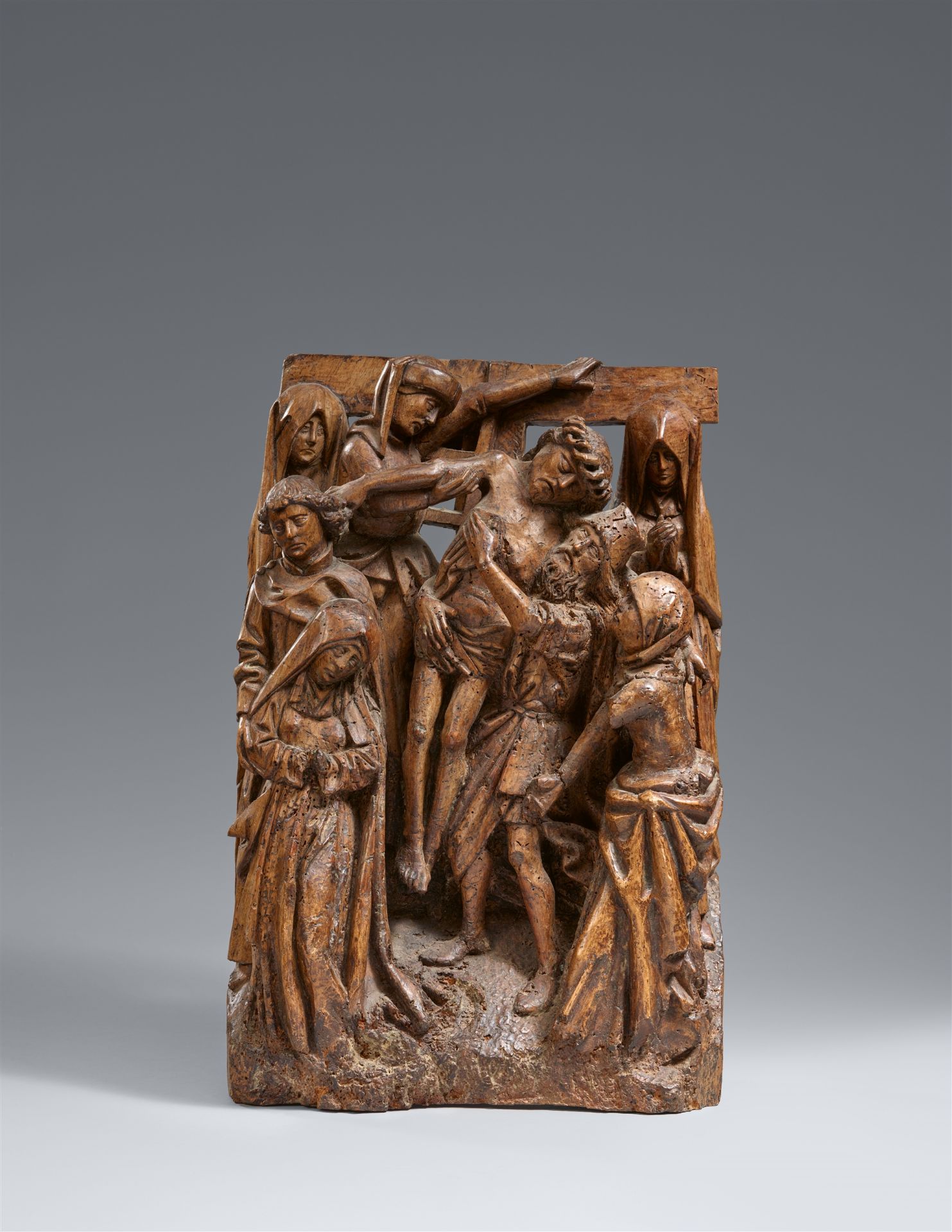 A late 15th century Brussels carved wood relief of the Deposition from the Cross