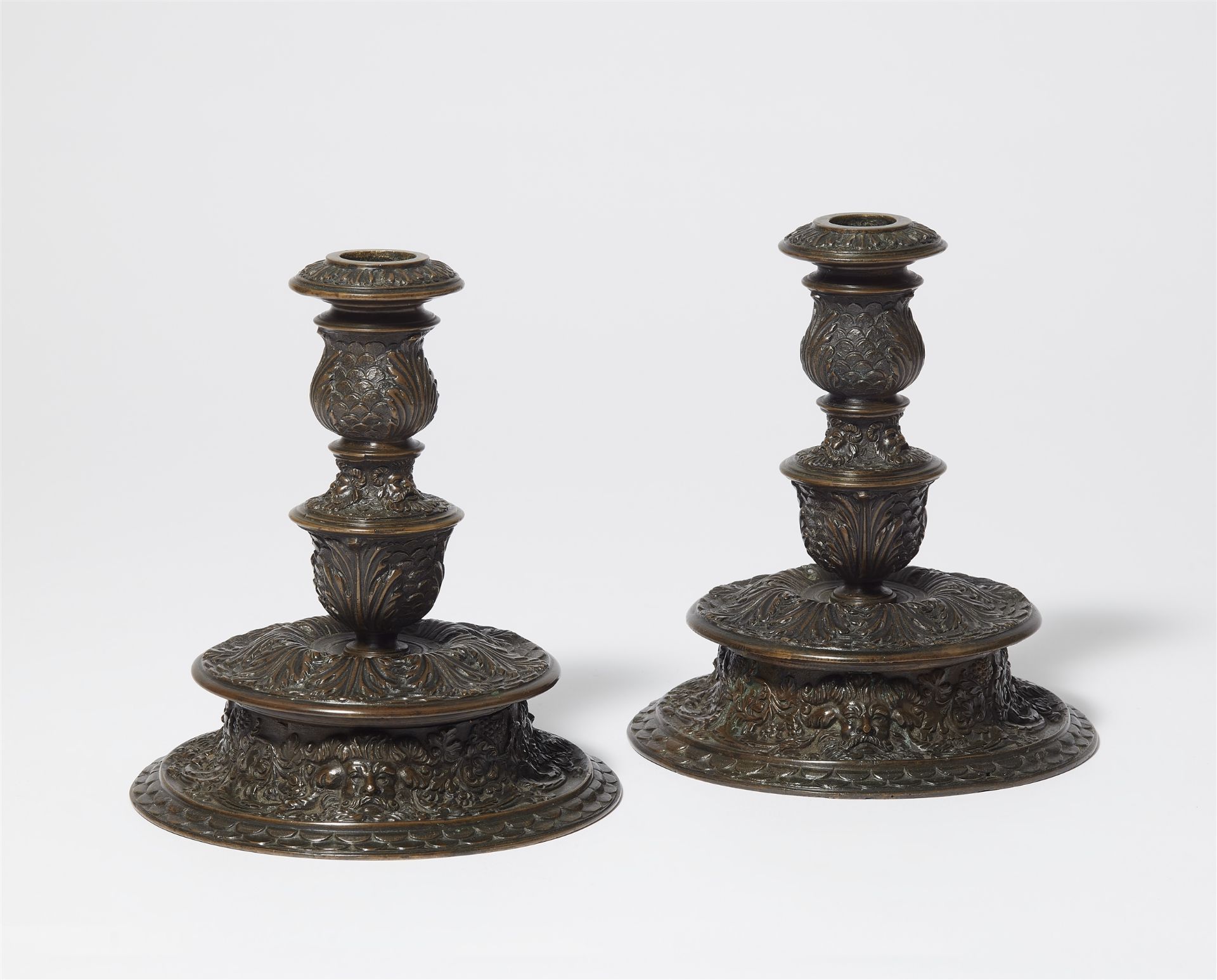 A pair of Italian Renaissance bronze candlesticks