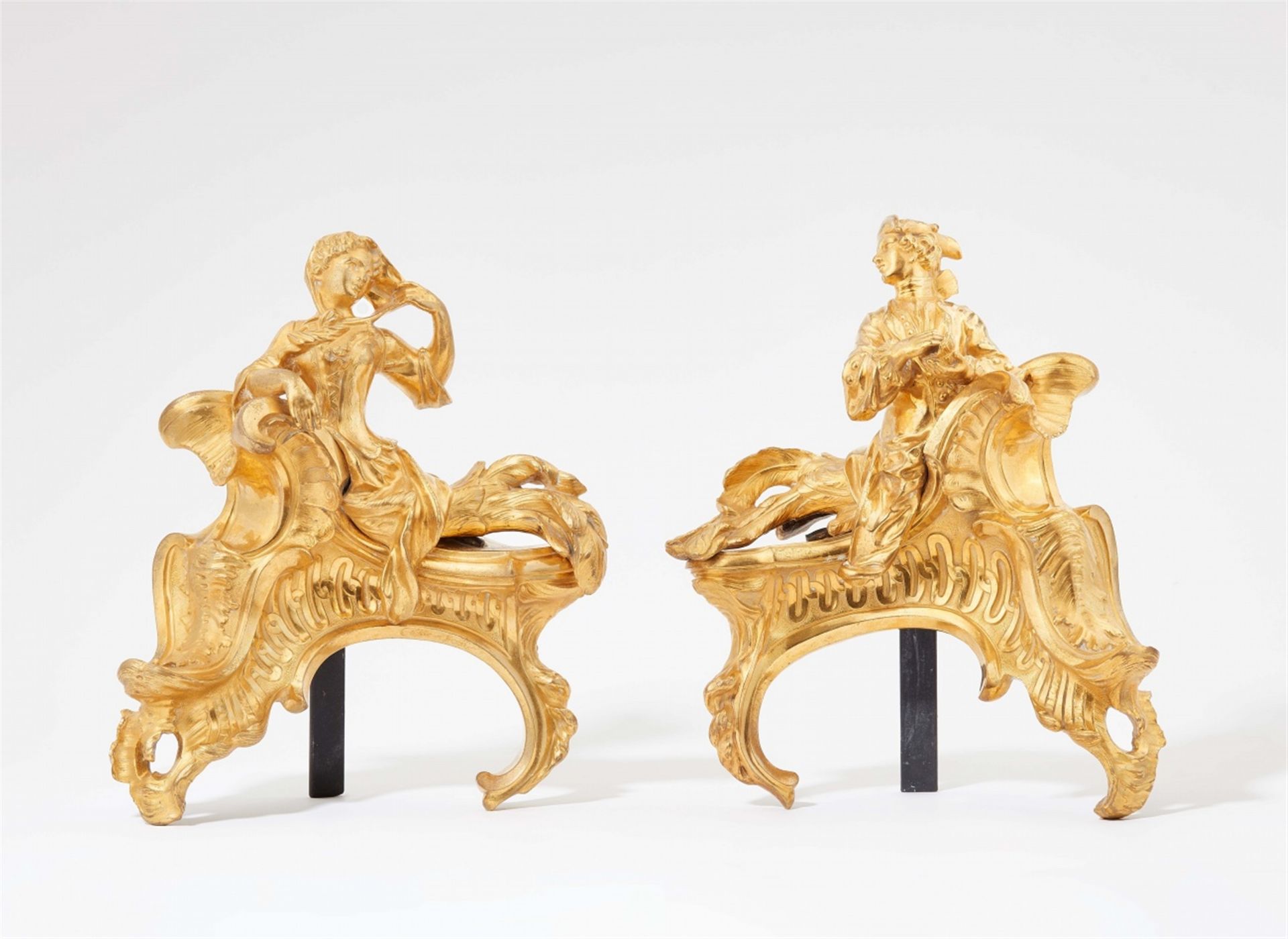 A pair of ormolu fire dogs by Jacques Caffiéri