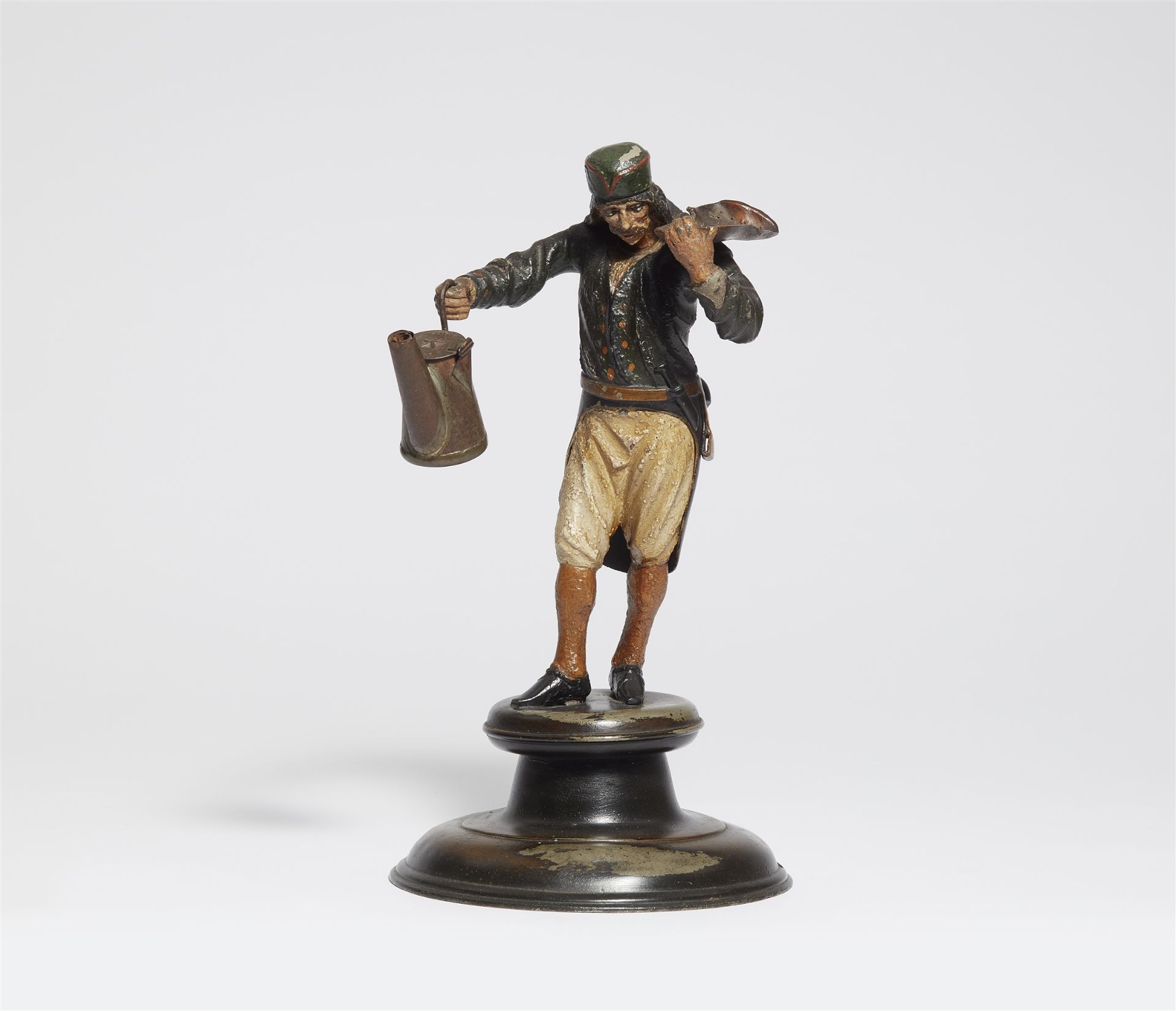 A pewter figure of a miner with an oil lamp