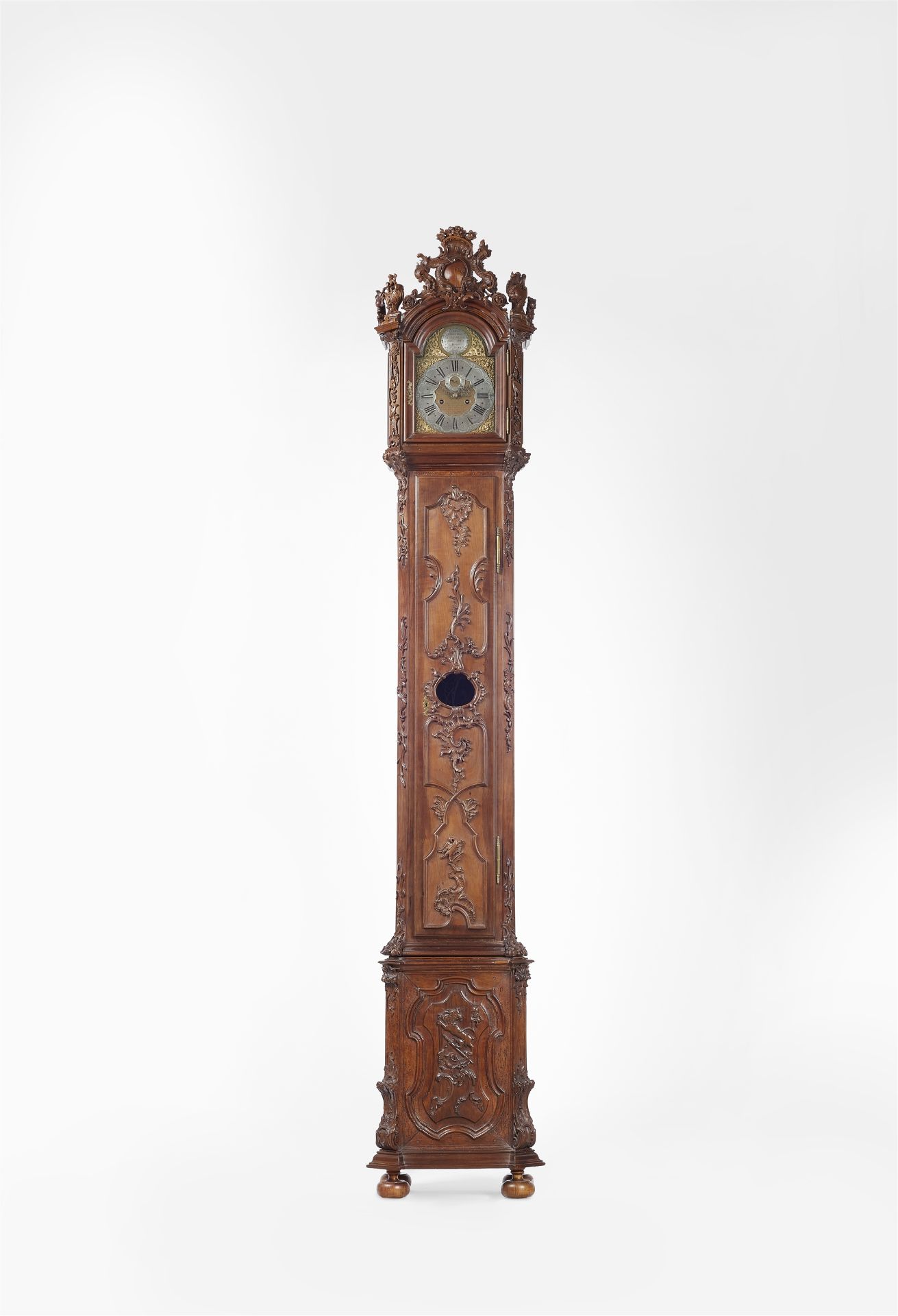 A museum quality longcase clock with a carved Vanitas still life