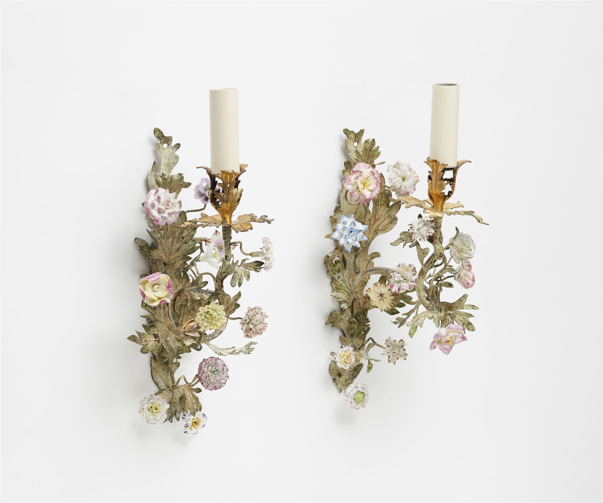 A pair of bronze appliques with porcelain flowers