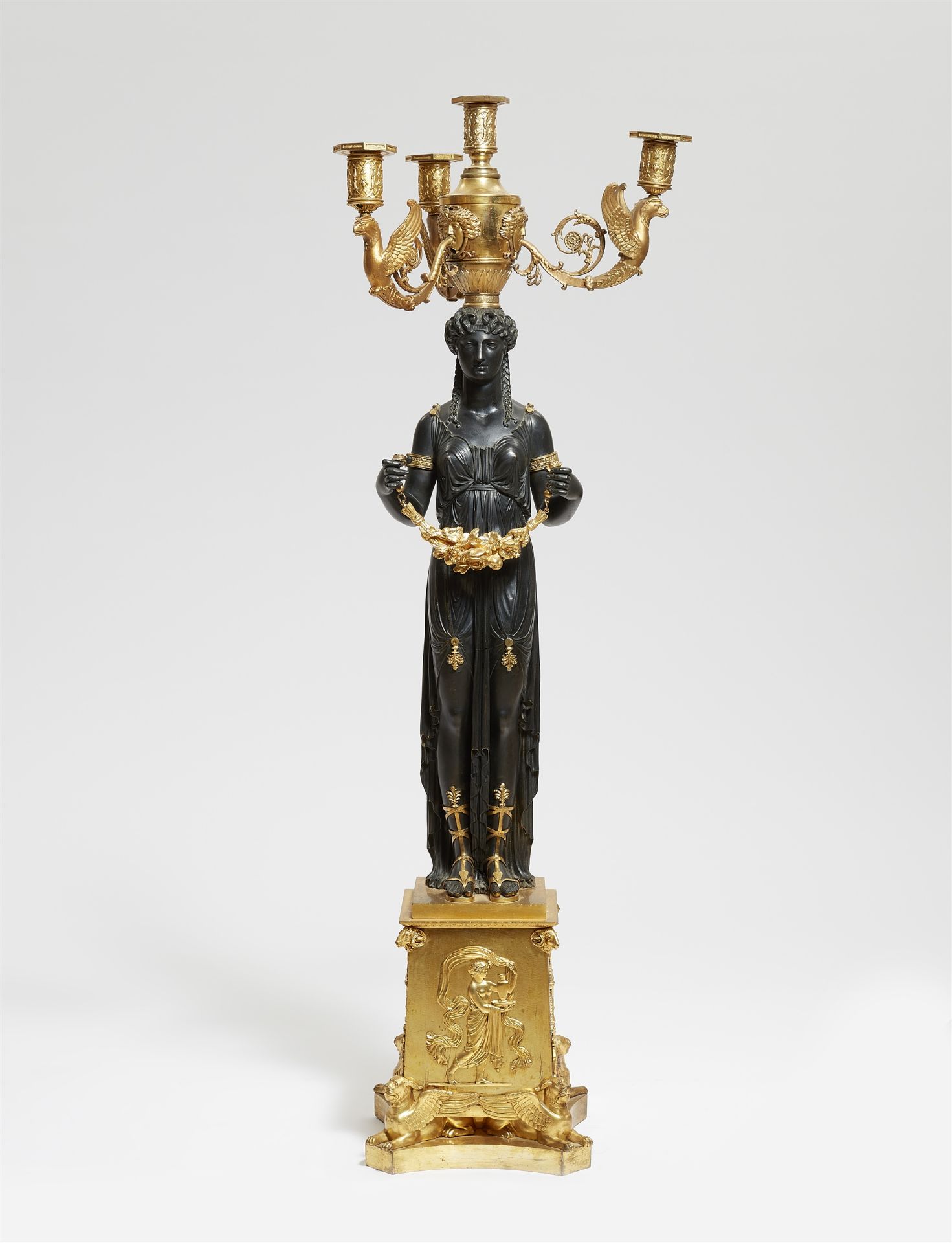 An important gilt and patinated bronze girandole with a figure of Isis/Demeter