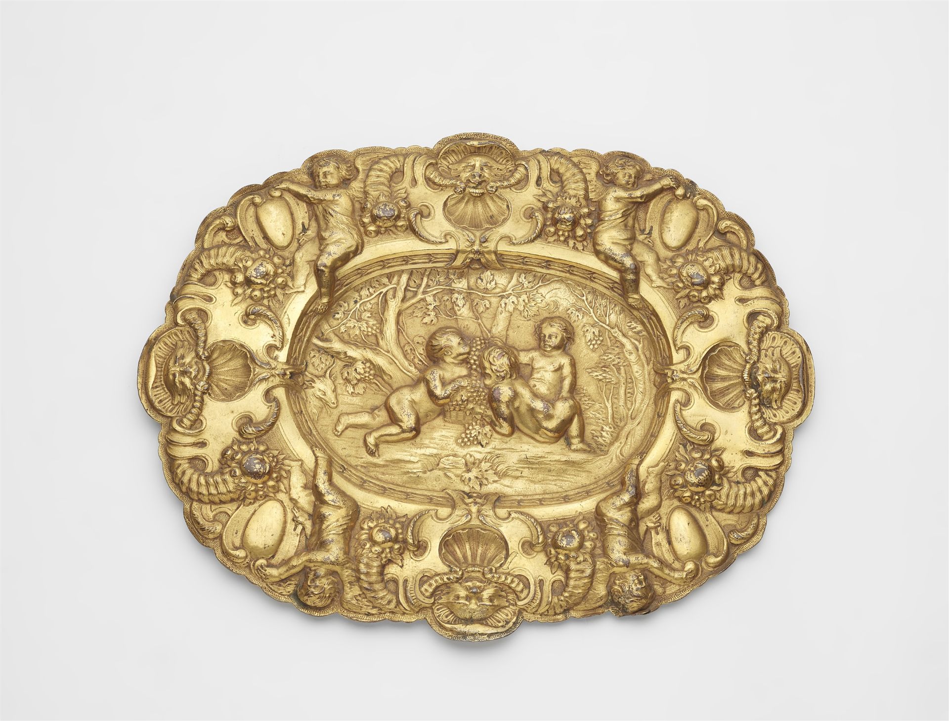 A gilt copper dish with putti as an allegory of autumn