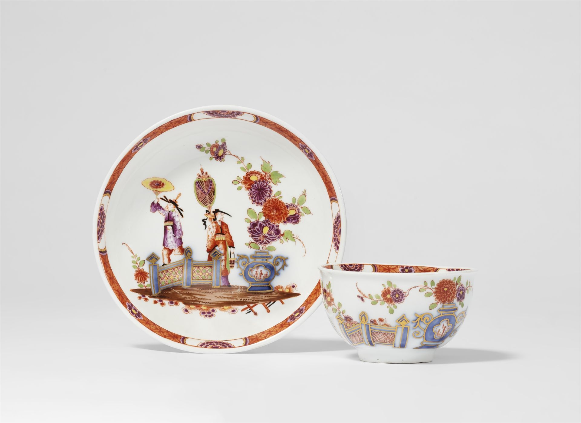 A Meissen porcelain tea bowl and saucer with Chinoiserie figures