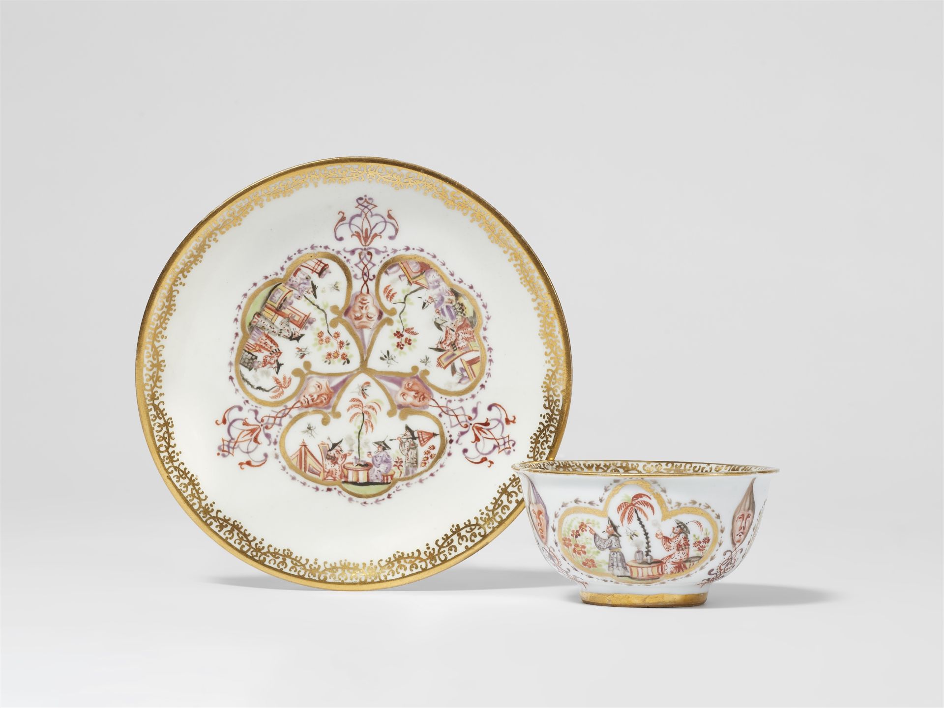A Meissen porcelain tea bowl and saucer with Chinoiserie decor
