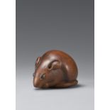 A boxwood netsuke of a seated rat. 19th century