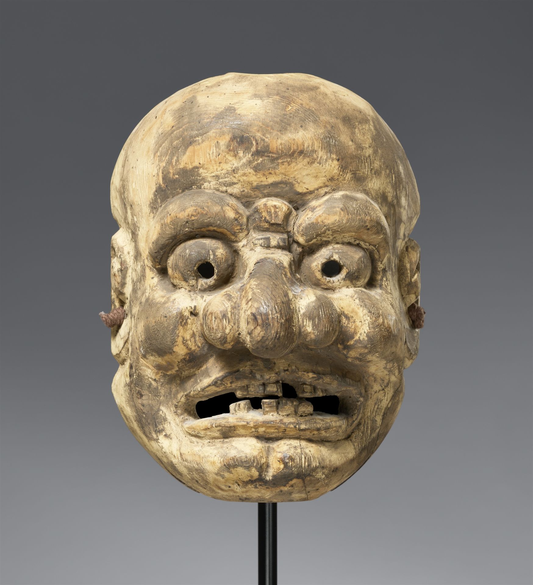A kiri wood mask of an old man. Edo period
