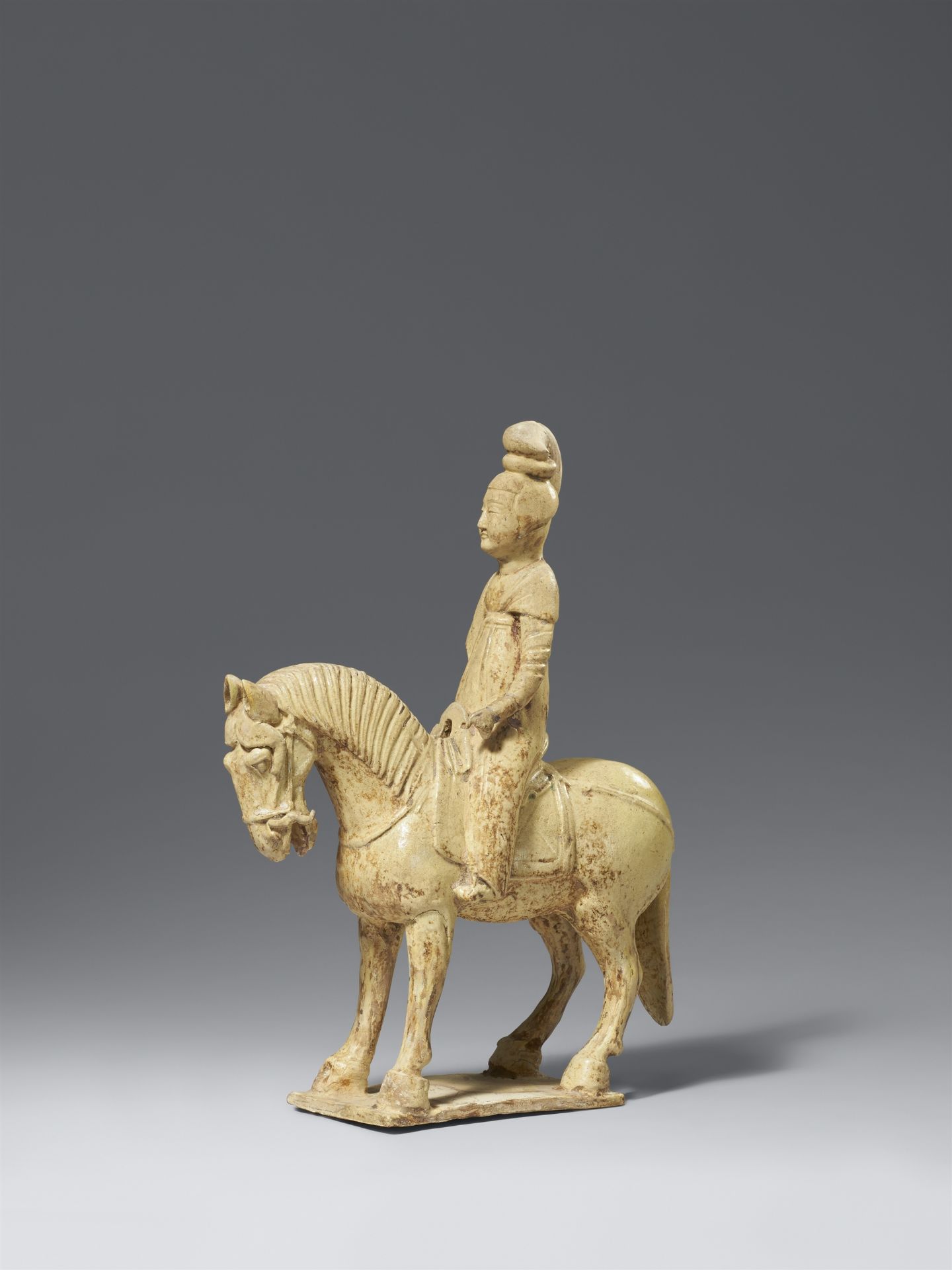 A straw-glazed pottery horse and female rider. Sui dynasty (581-618)