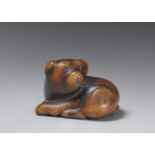 A large boxwood netsuke of a puppy. Early 19th century