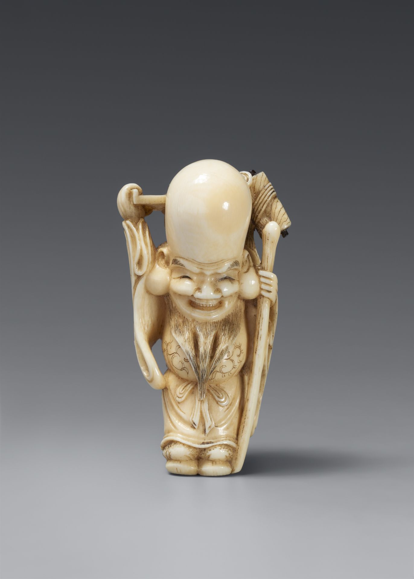 An amusing ivory netsuke of Fukurokuju and karako 19th century