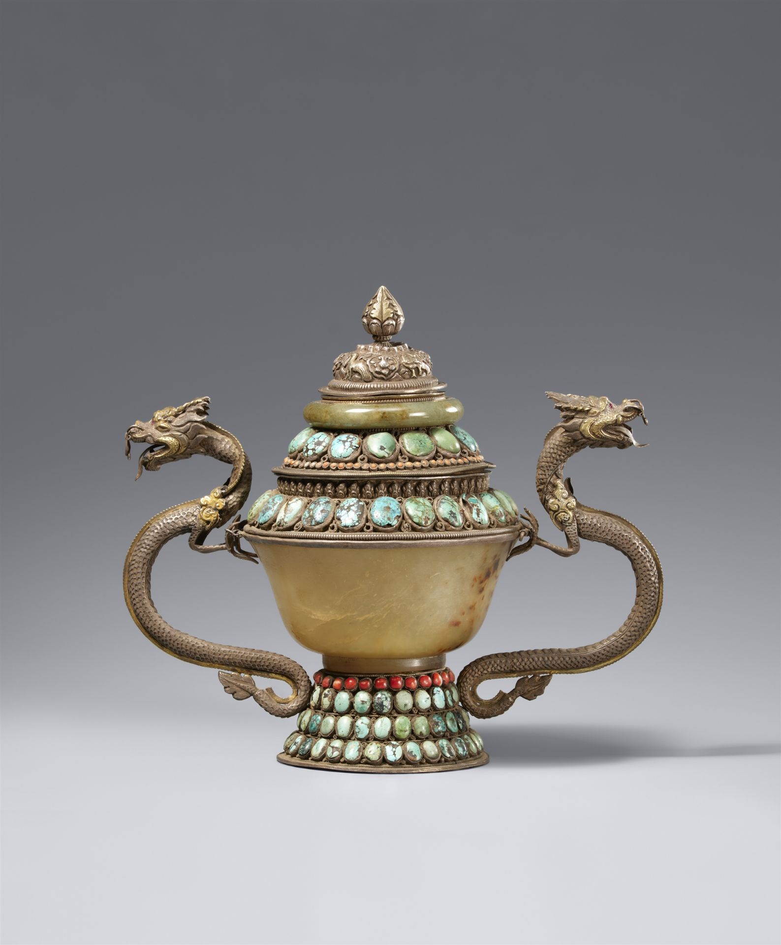 A silver-mounted and inlaid turquoise, coral and jade-embellished bowl and cover. Tibet, 19th/20th c