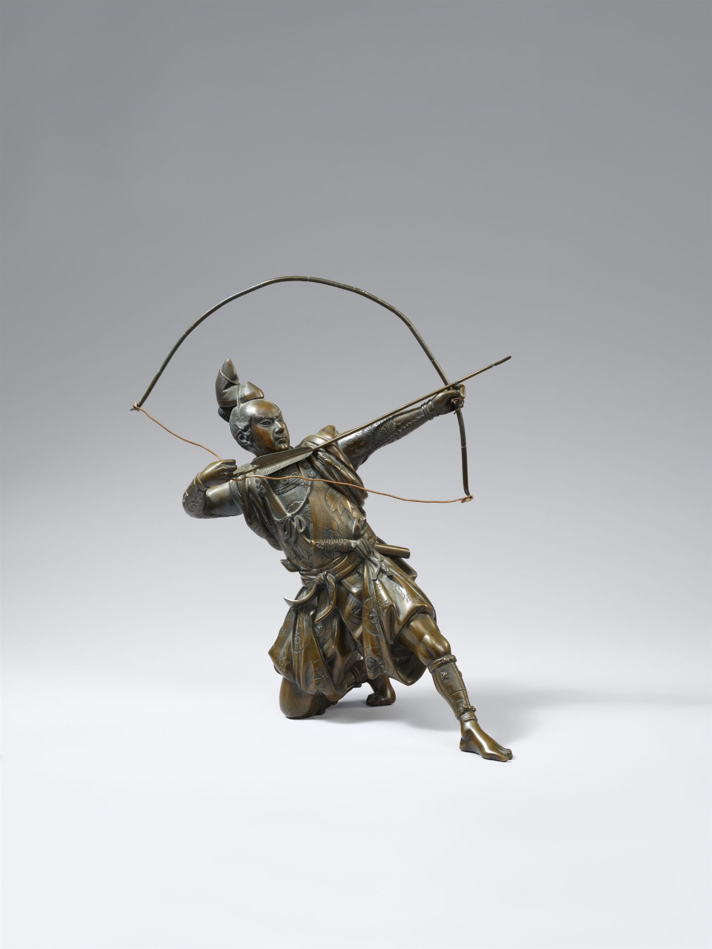 A copper alloy figure of an archer by Yoshimitsu. Around 1900