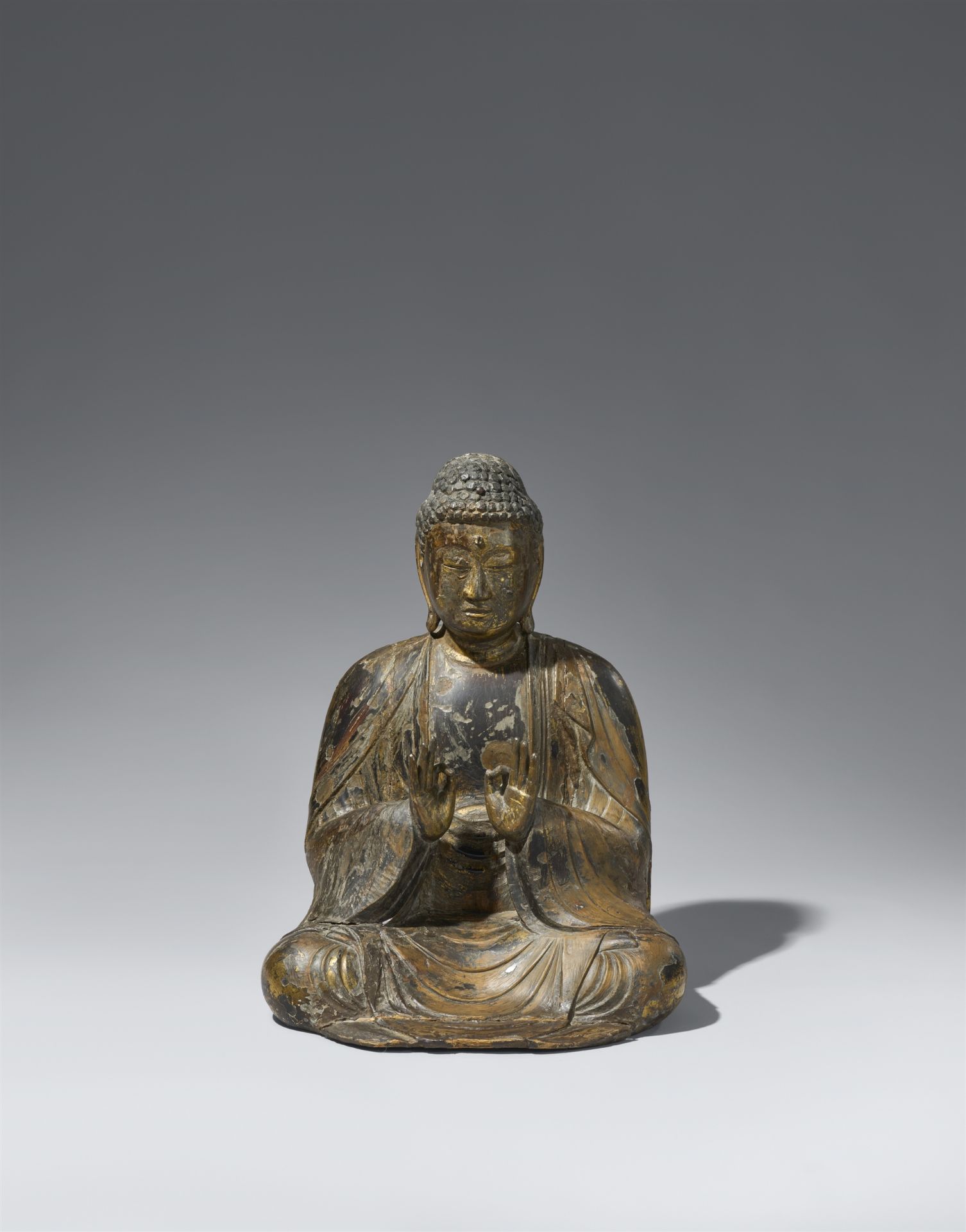 A wood figure of a Buddha. 12th century or later