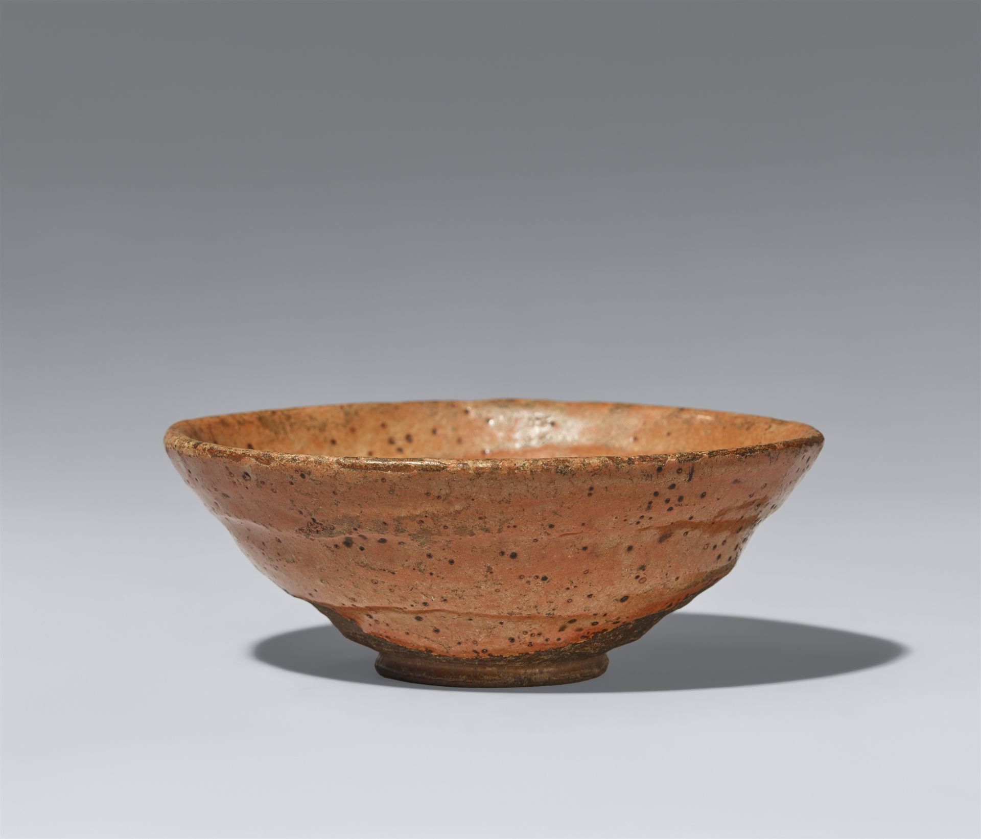 An oval-shaped aka raku chawan. Kyoto. 18th century