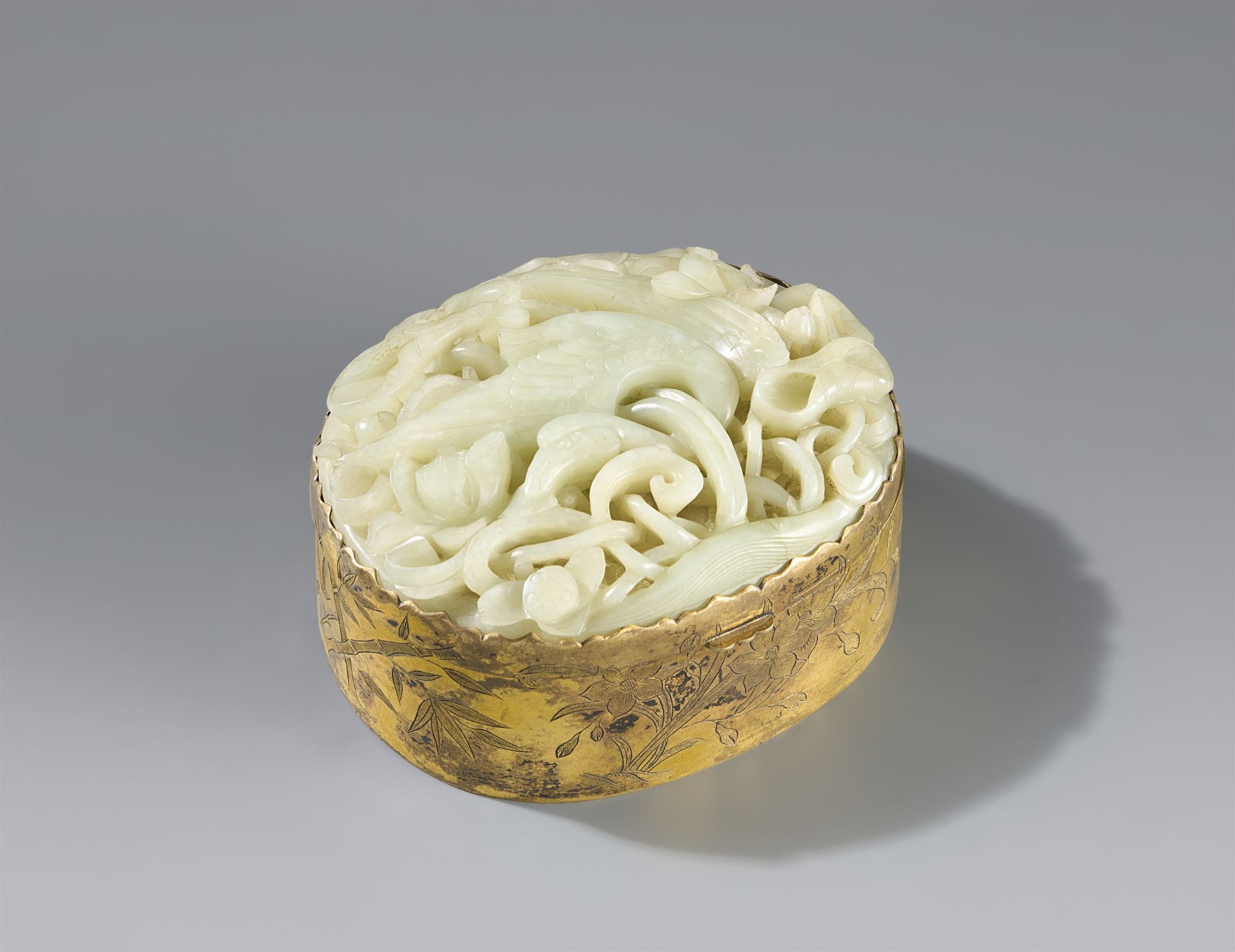 A copper gilt box with jade medallion. Late Qing period