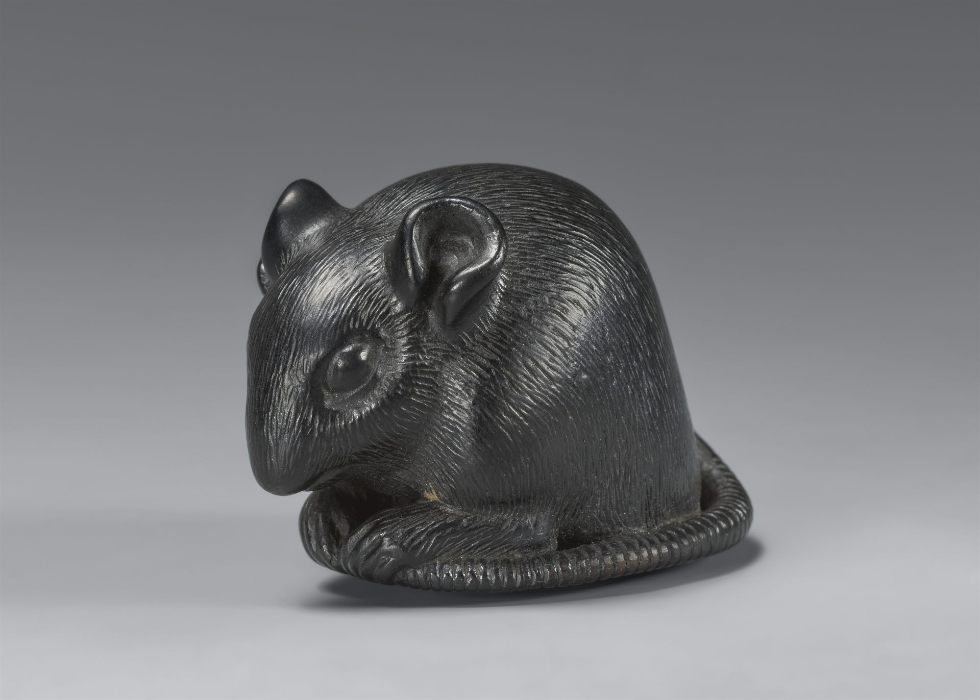 A blackwood netsuke of crouching rat. 19th century