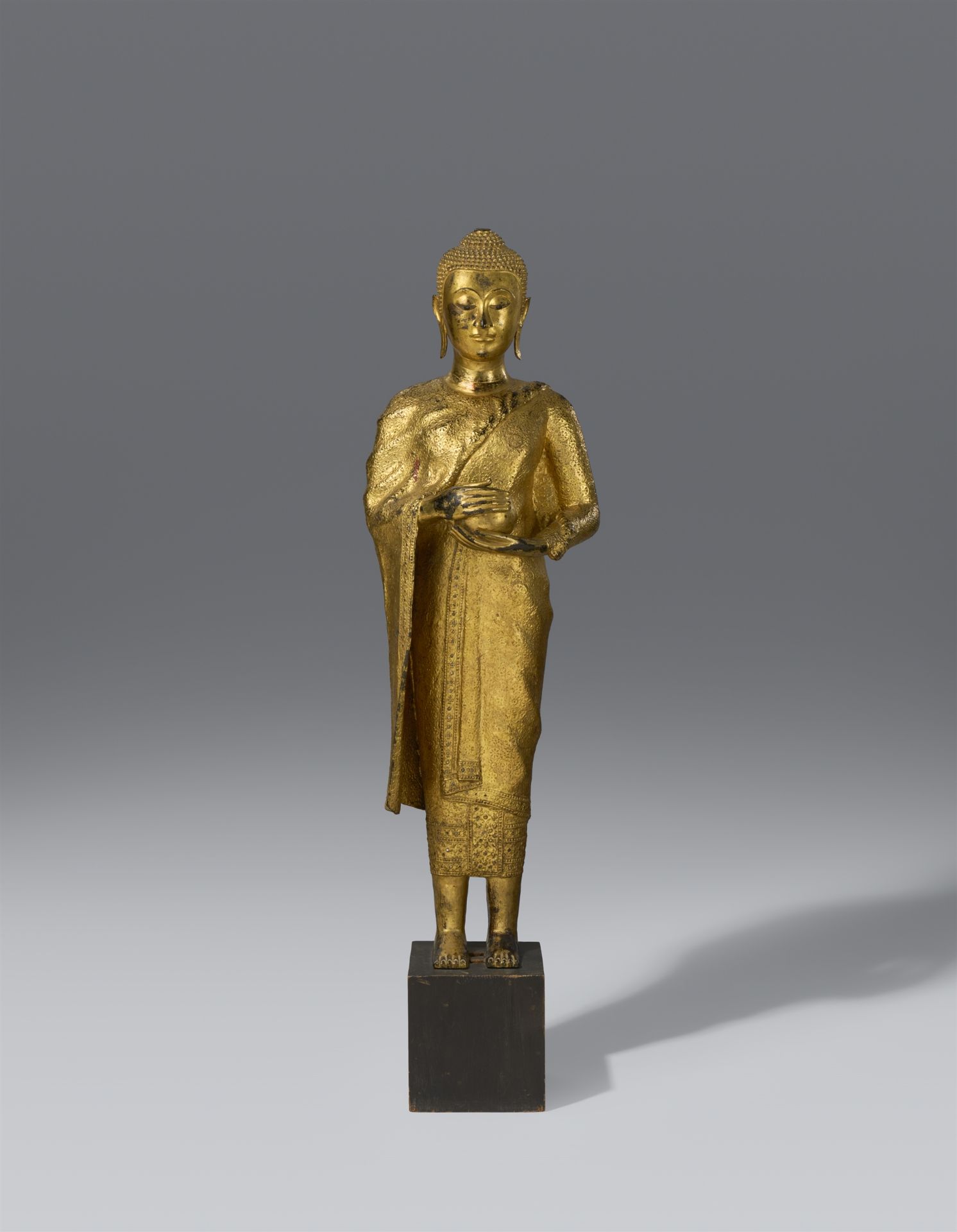 A Ratanakosin gilt and lacquered bronze figure of a Buddha. Thailand. 20th century