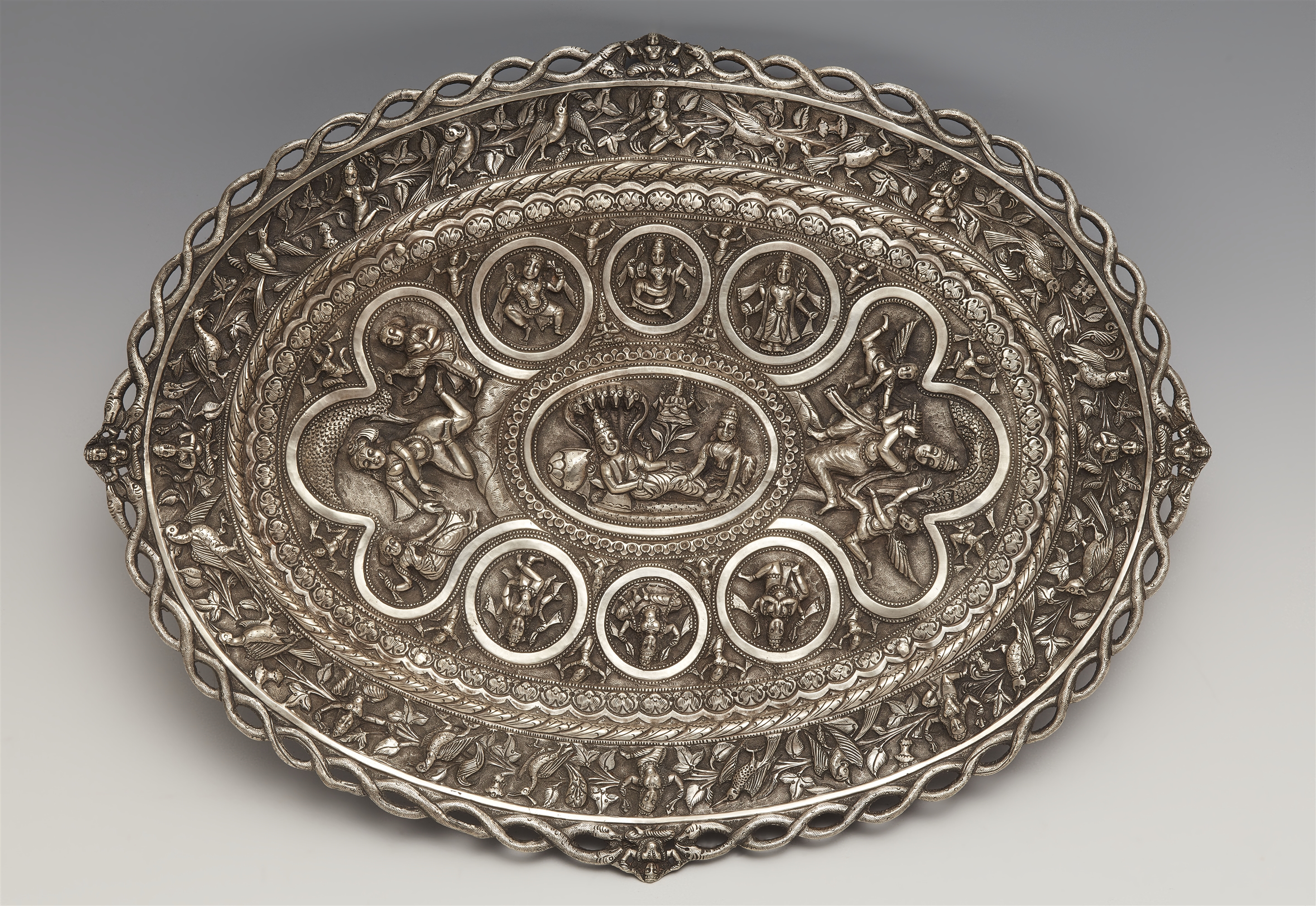 A Poona oval silver swami pattern footed tray. Late 19th century