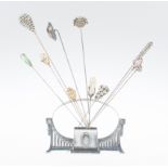 Silvered metal for hat pin holder with a collection of eleven hat pins. Württenbergische Metallware