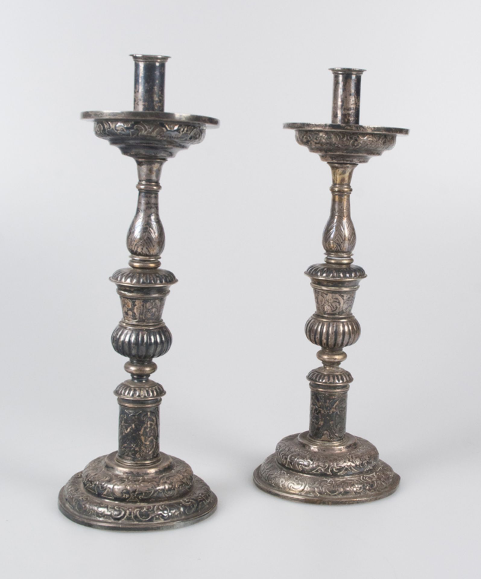 Pair of embossed and chased Spanish silver candlesticks. 16th 17th century.