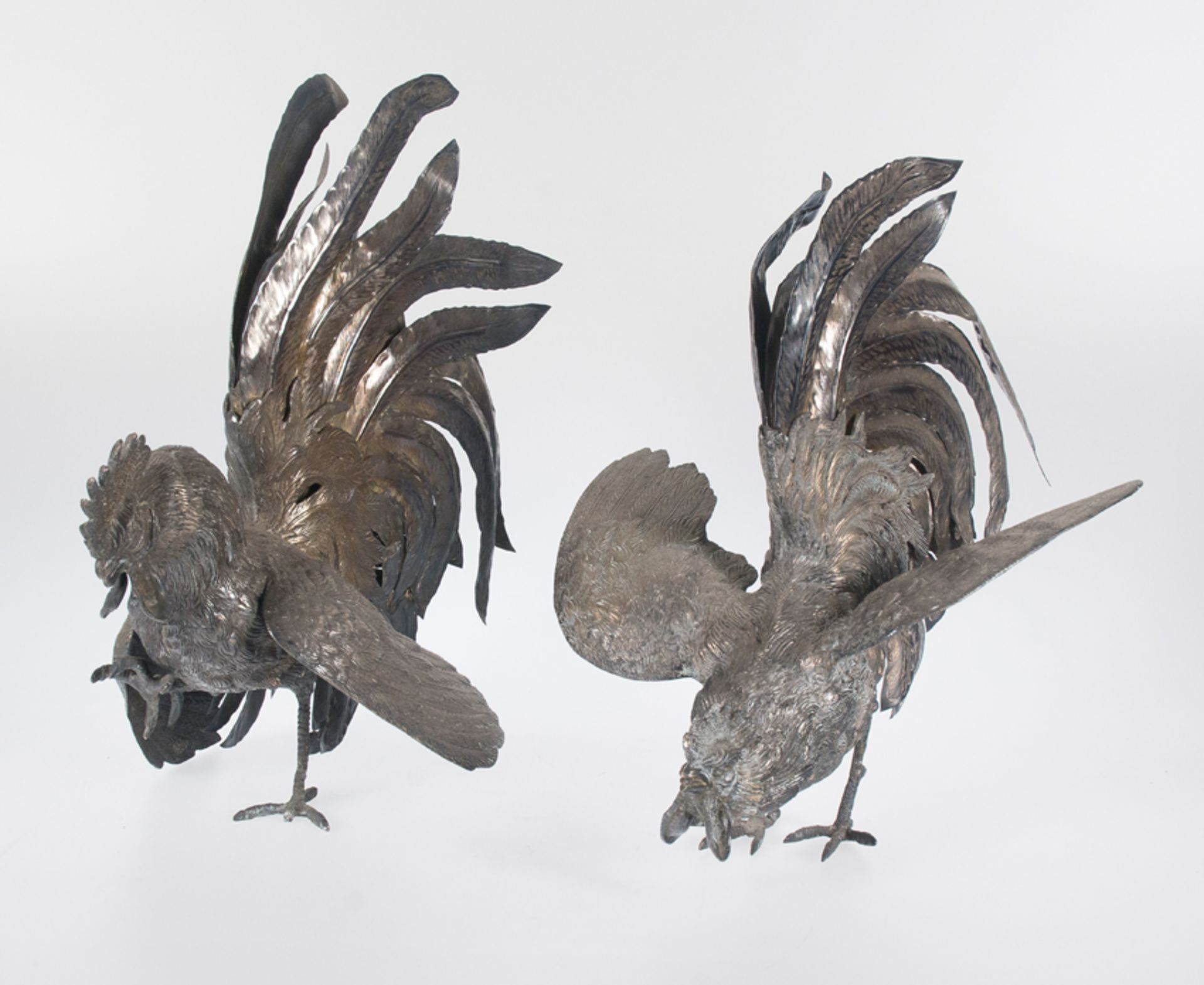 Pair of large embossed and chased silver roosters. Colonial work.Possibly Peru. 19th century
