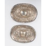 Pair of small, embossed and marked 916 silver salvers. 19th century.