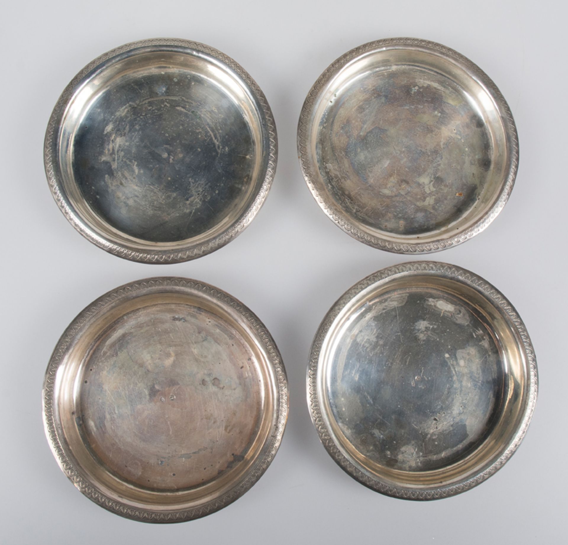 Set of four silver bottle bases. Marked "Carreras" and with Barcelona marks .